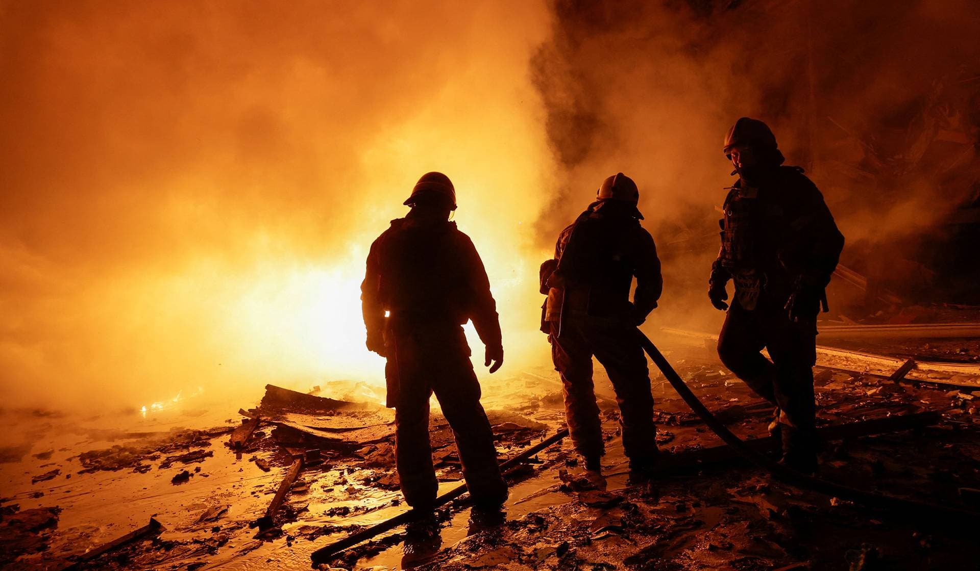 Firefighters work at the site of a logistics hub of a private delivery company hit by a Russian missile strike in Kharkiv