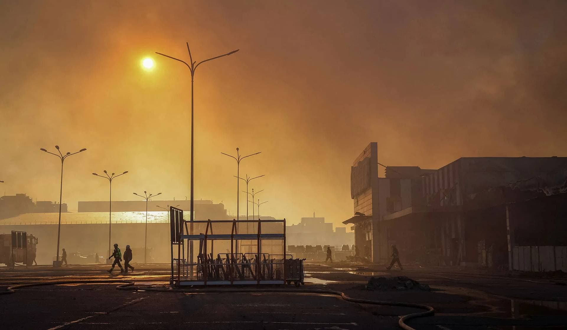 Firefighters work at a site of a household item shopping mall hit by a Russian air strike in Kharkiv