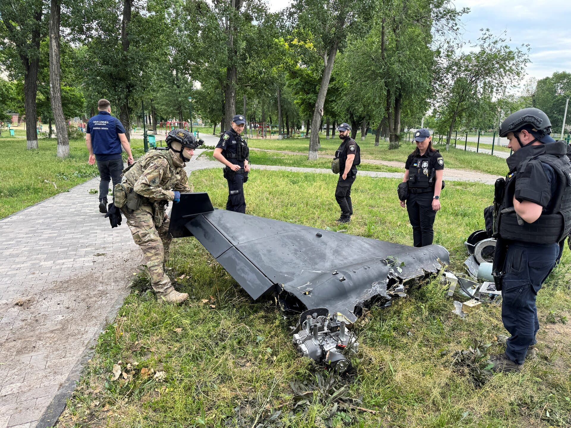 A police bomb squad member inspects a Russian kamikaze drone at the site of the Russian drone strike in Kharkiv
