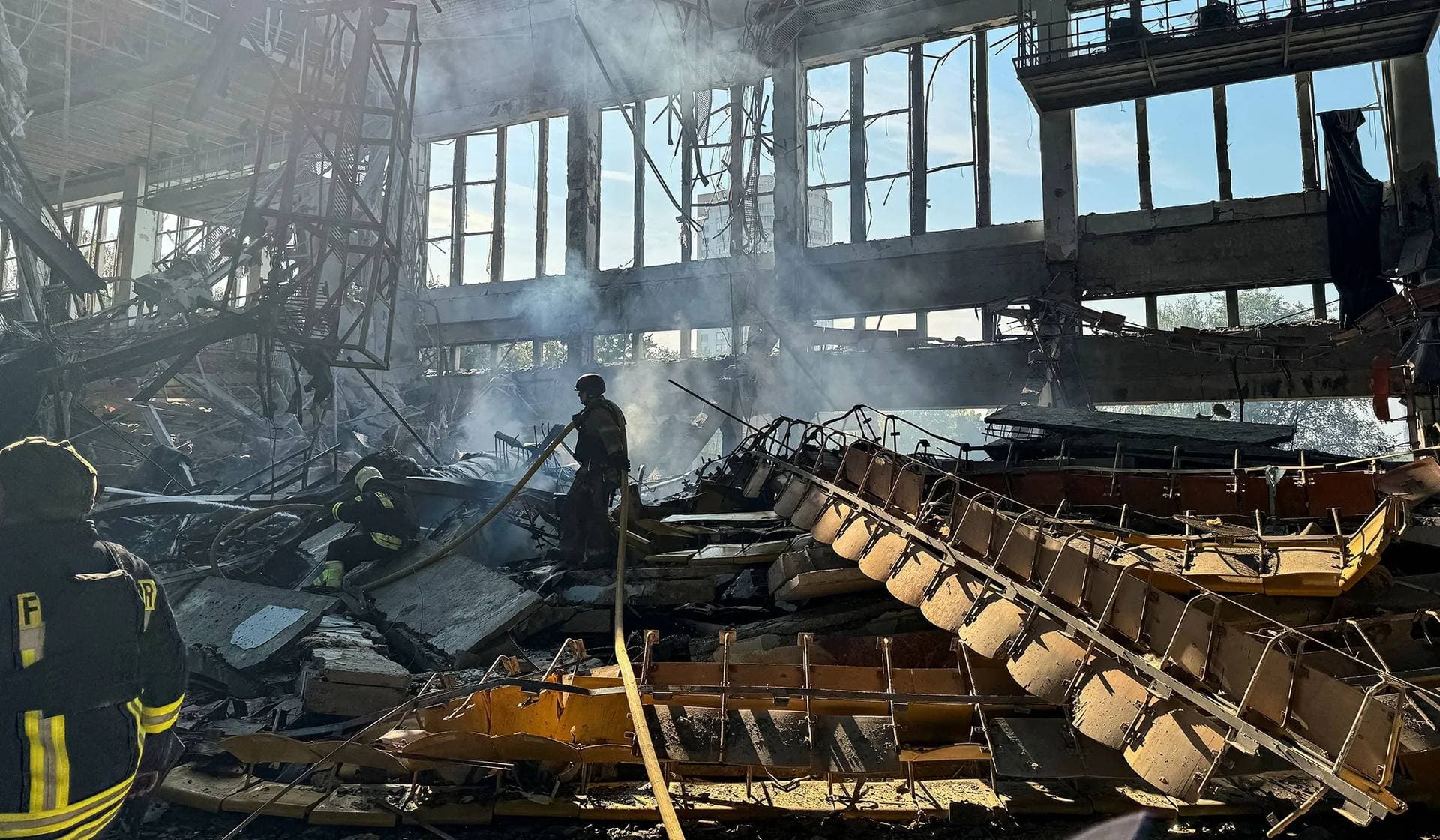 Firefighters work at the site of a Russian missile strike in Kharkiv