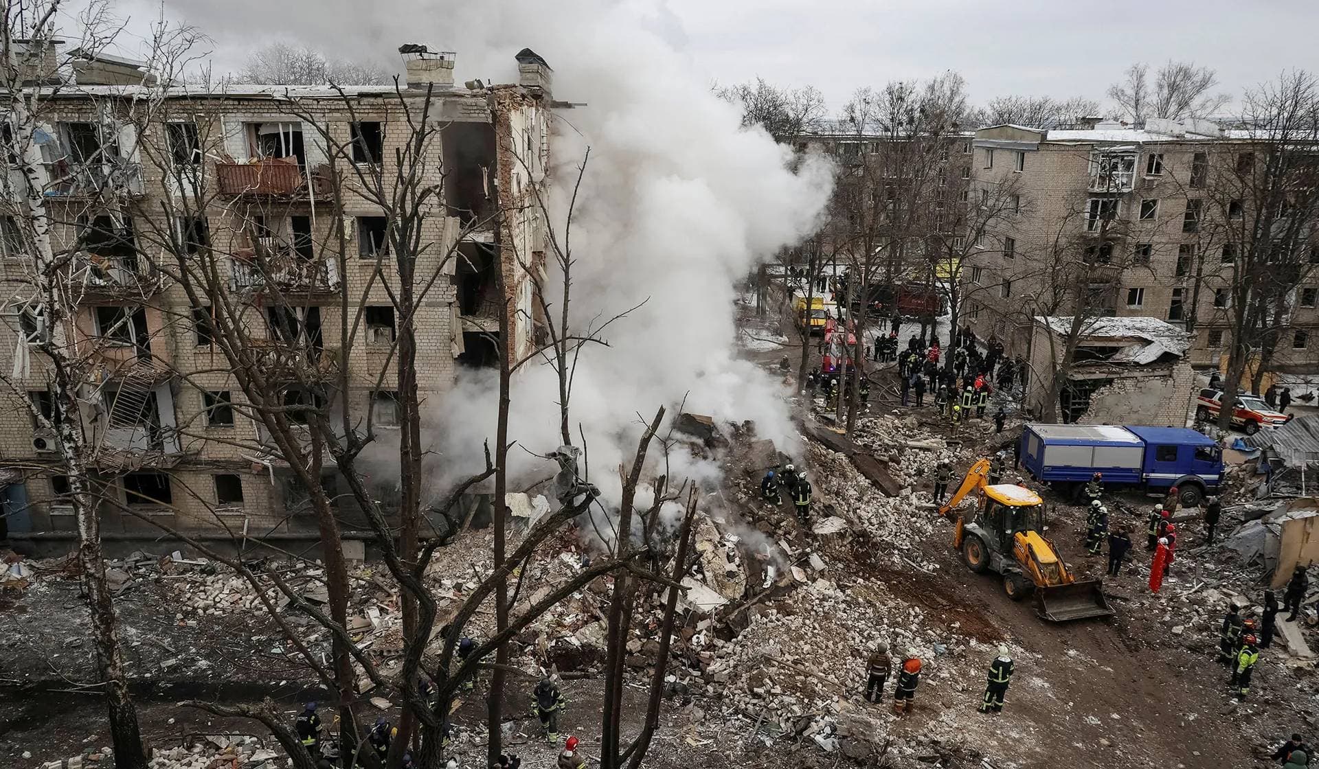 Rescuers work at a site of a residential building heavily damaged during a Russian missile attack in Kharkiv