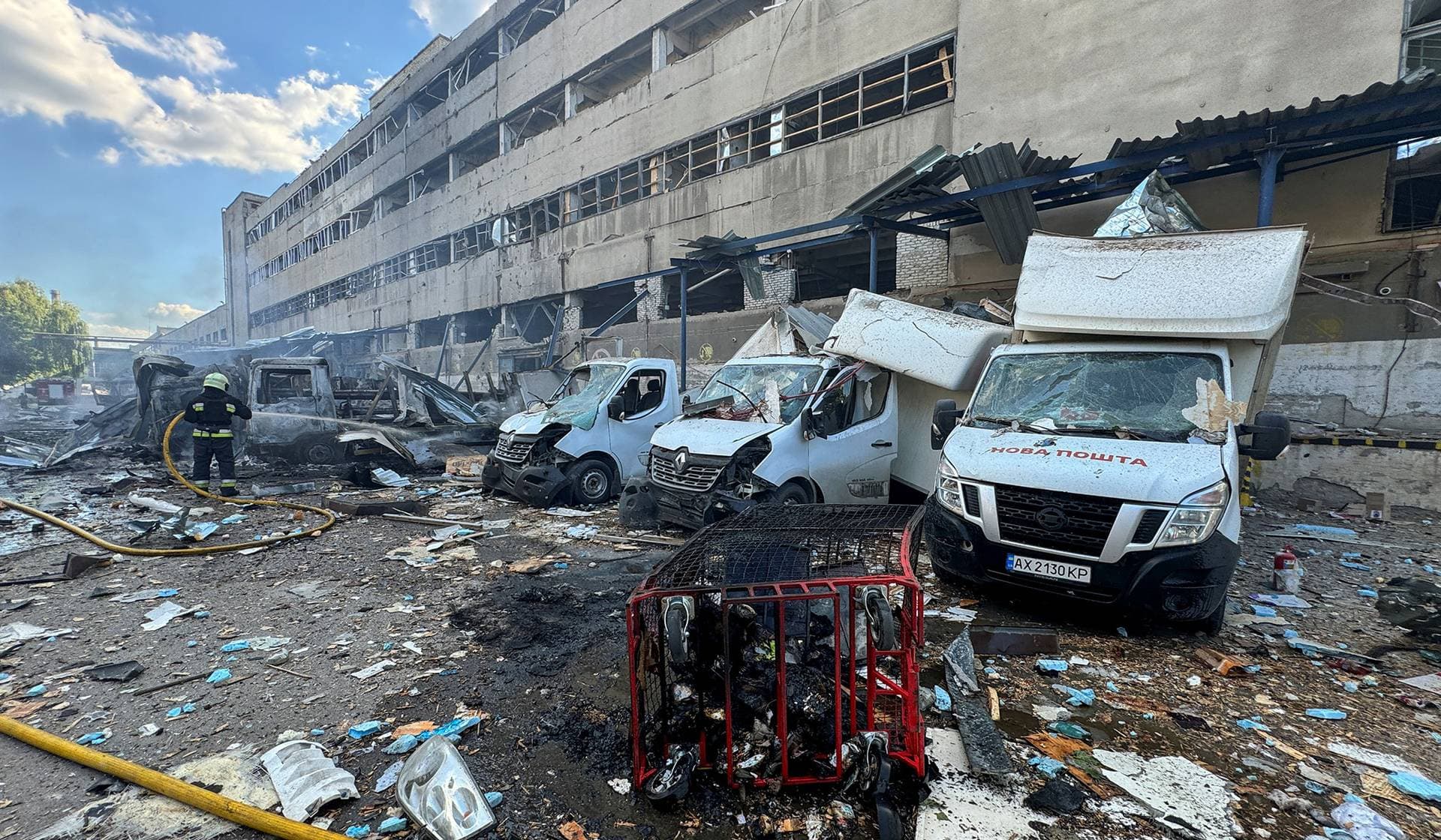 A firefighter works at a postal operator branch hit by a Russian air strike in Kharkiv
