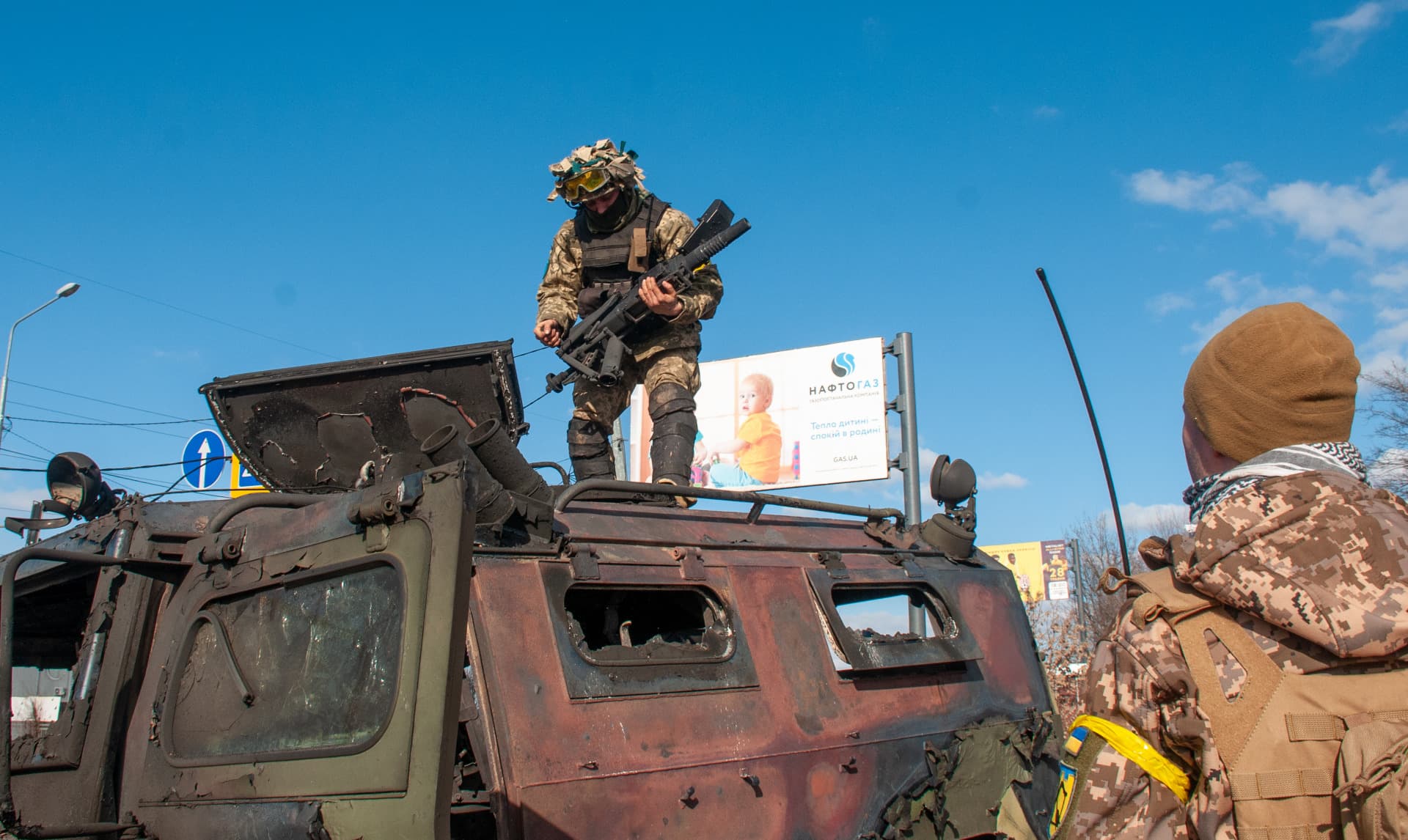 Soldiers near the burnt Russian AFV Tiger in Kharkiv