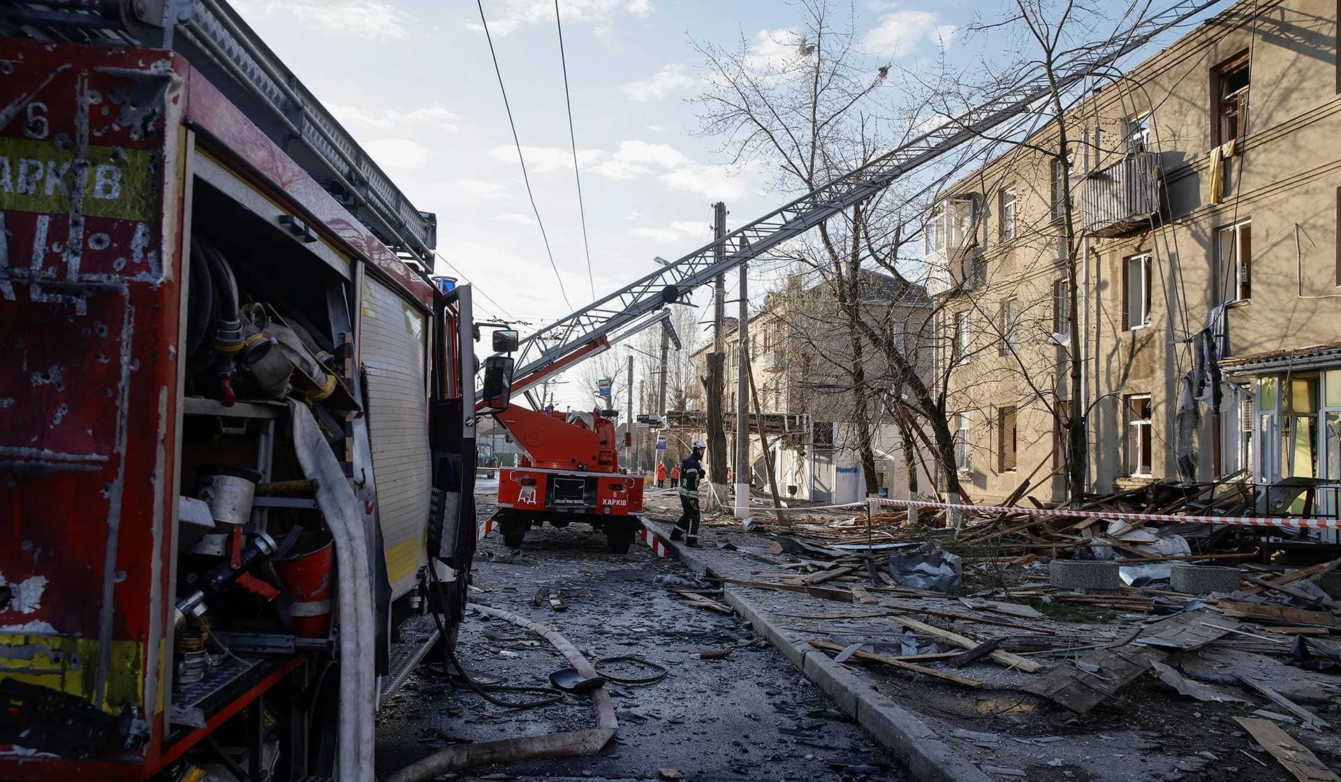 A rescuer works at a site of a Russian drone strike in Kharkiv