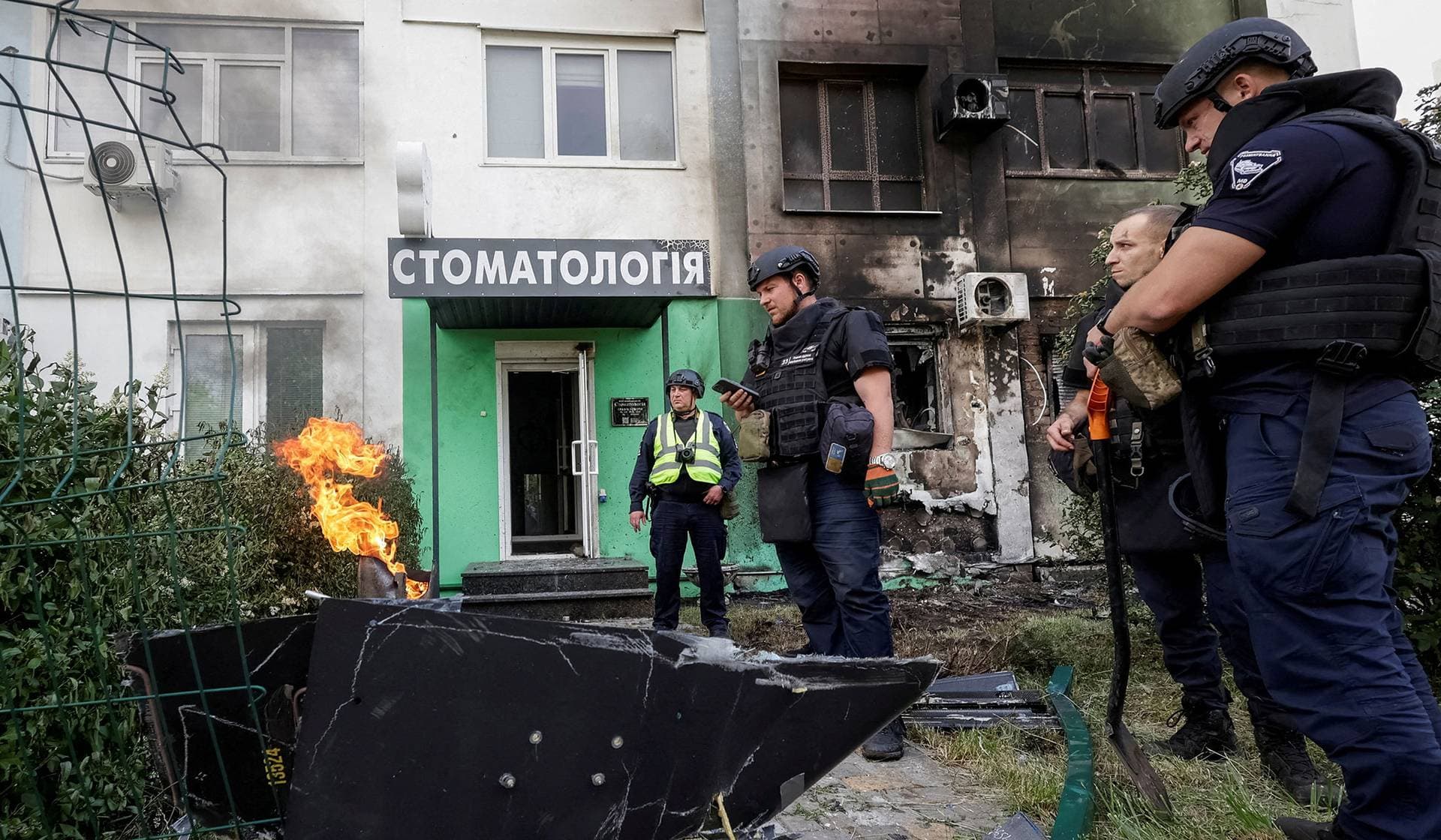 Police experts work at the site of a Russian drone strike in Kharkiv