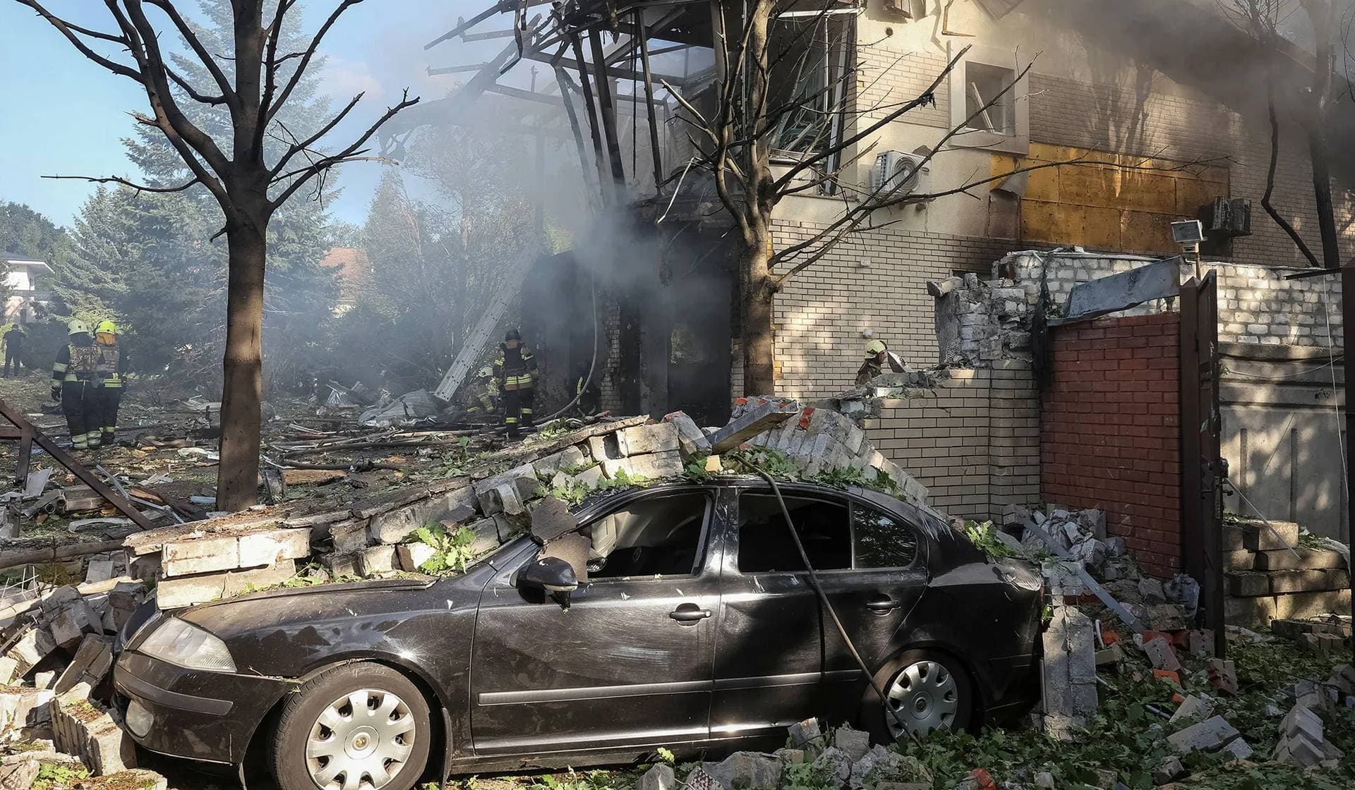Firefighters work at a site of a private house destroyed during a Russian missile attack in Kharkiv