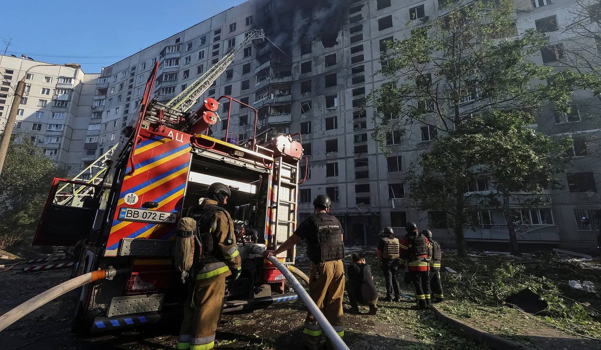 Firefighters work at a site of a Russian air strike in Kharkiv