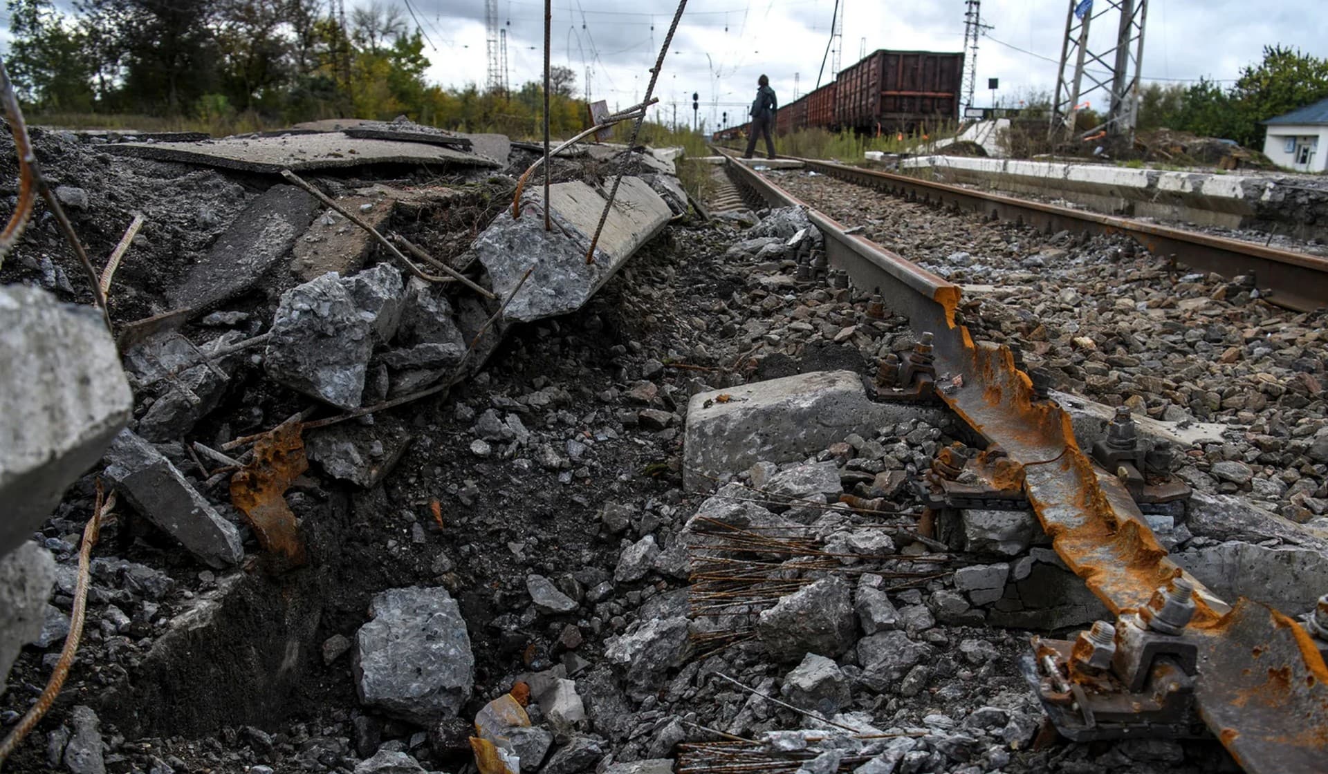 A shell crater at a railway station in the village of Kozacha Lopan