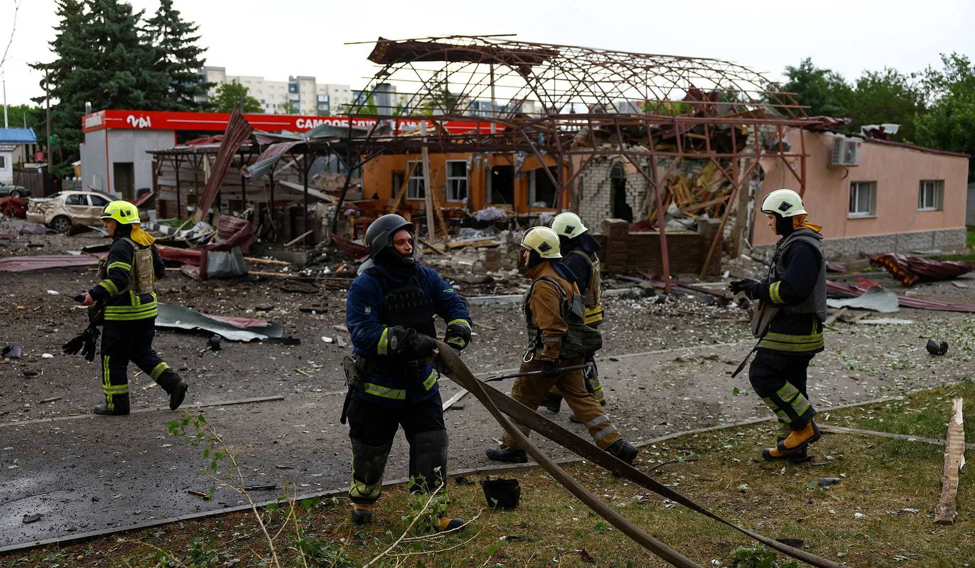 Firefighters work at a site of a Russian air strike in Kharkiv