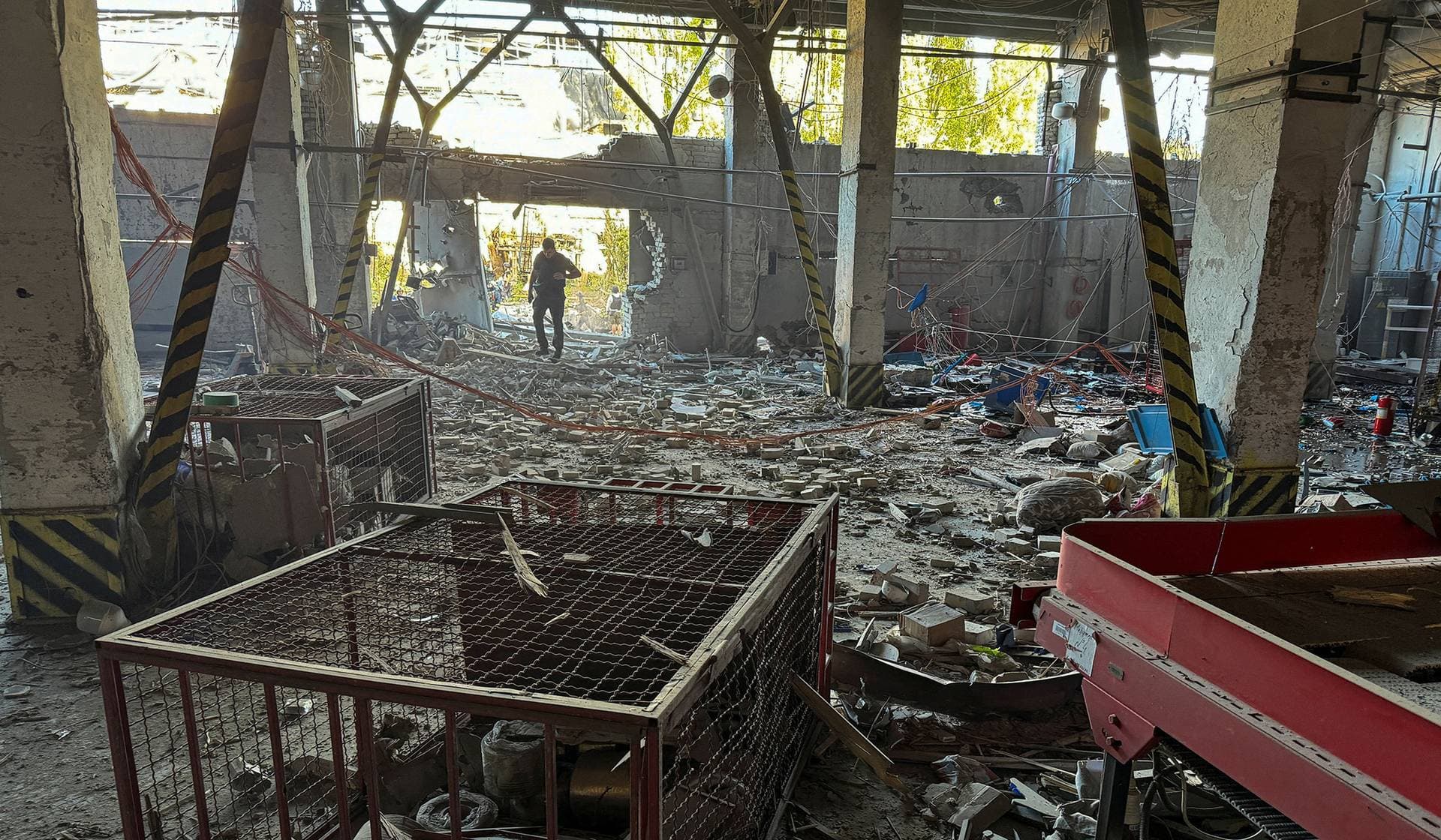 A police officer inspects a postal operator branch hit by a Russian air strike in Kharkiv