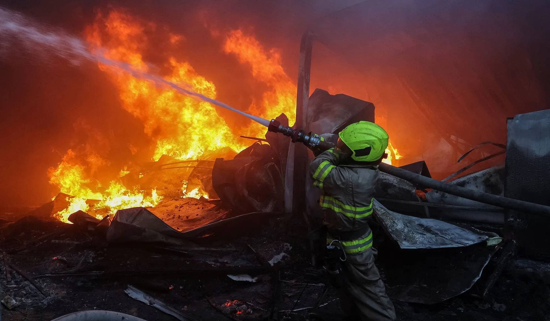 A firefighter works at a site a Russian missile strike in Kharkiv