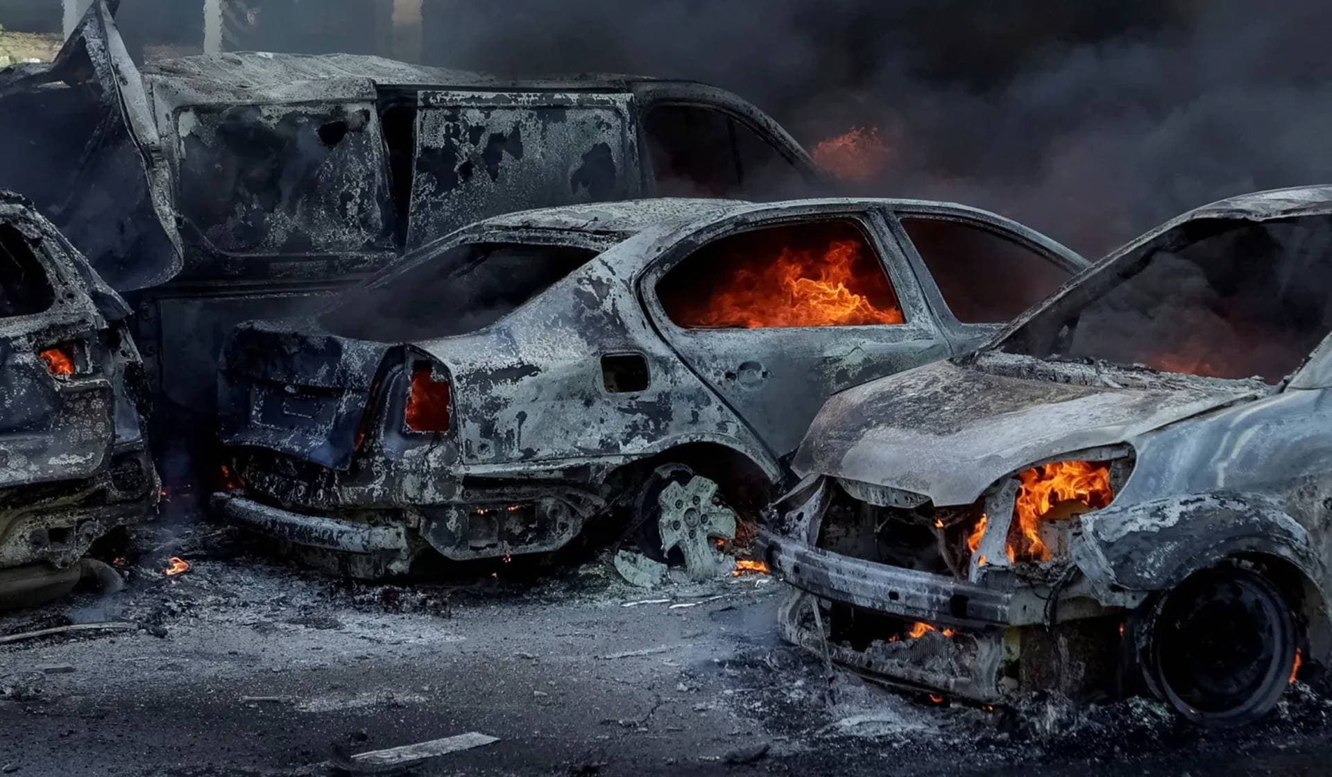Cars burn at the site of a Russian air strike in Kharkiv