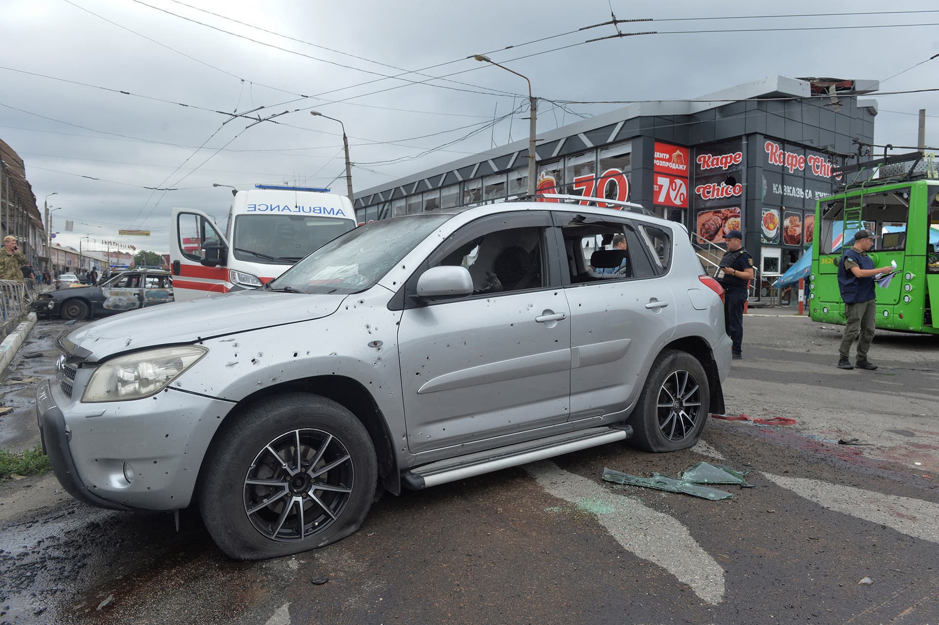 Investigators work at the site of a Russian military strike in Kharkiv