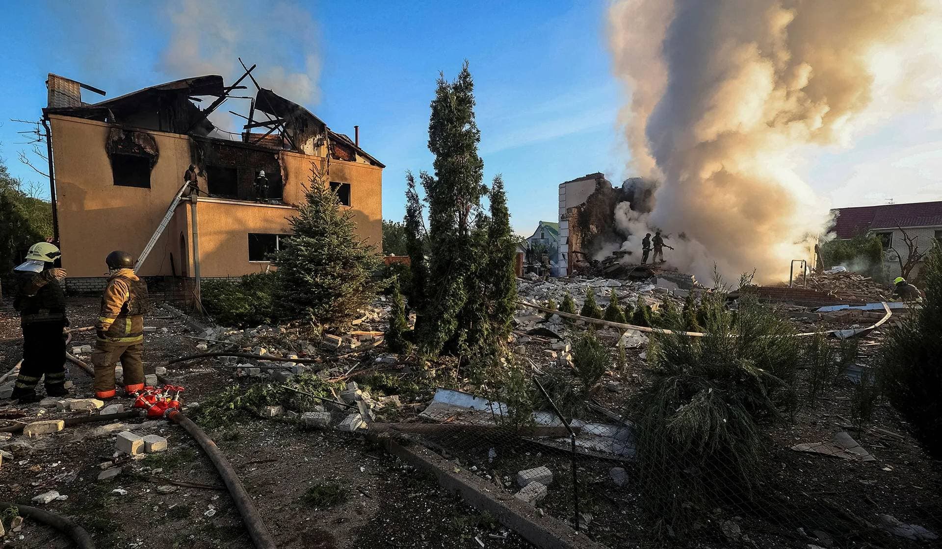 Firefighters work at a site of a Russian missile strike in Kharkiv