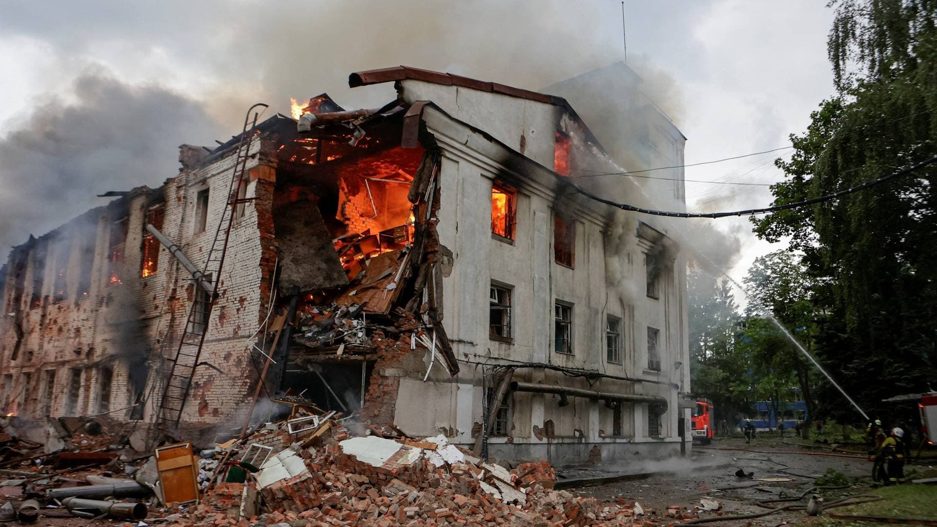 Firefighters work at the site of a building hit by a Russian drone strike in Kharkiv