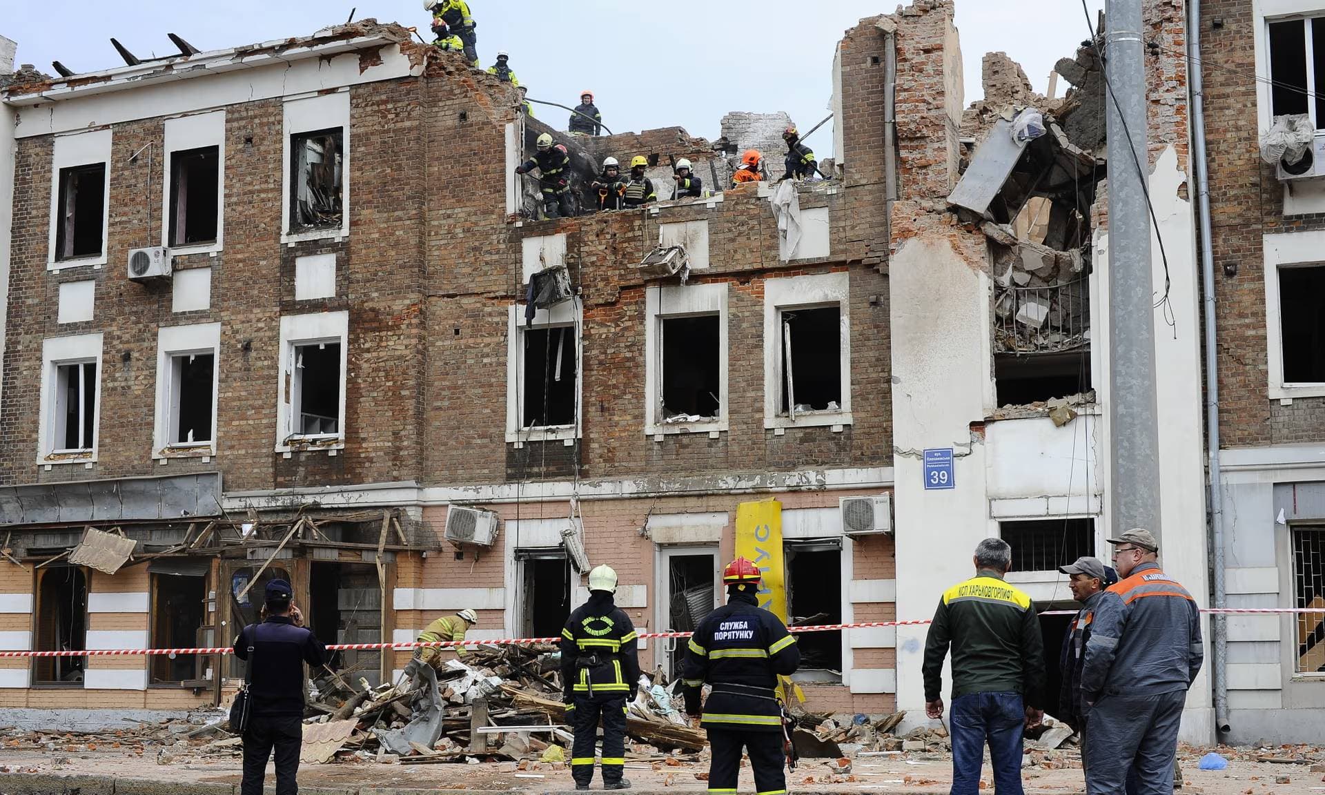 Rescuers and utility workers gathered at the site of a missile hit on 6 October in Kharkiv