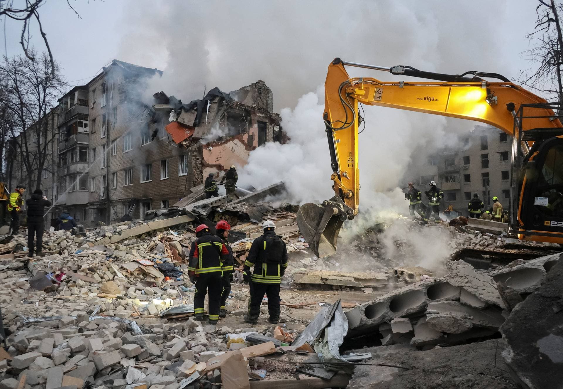 Rescuers work at the site of an apartment building hit by a Russian missile strike in Kharkiv