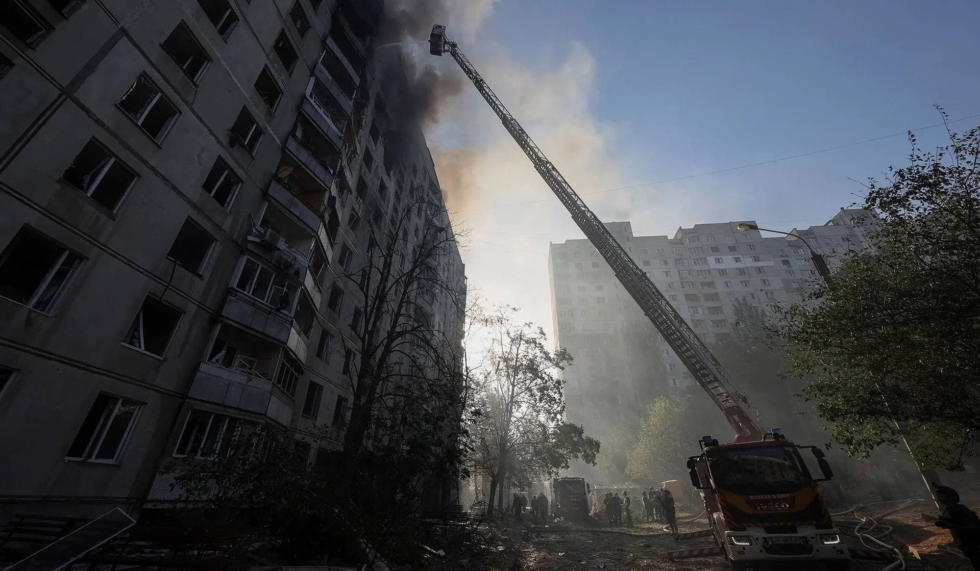 Firefighters work at a site of a Russian air strike in Kharkiv