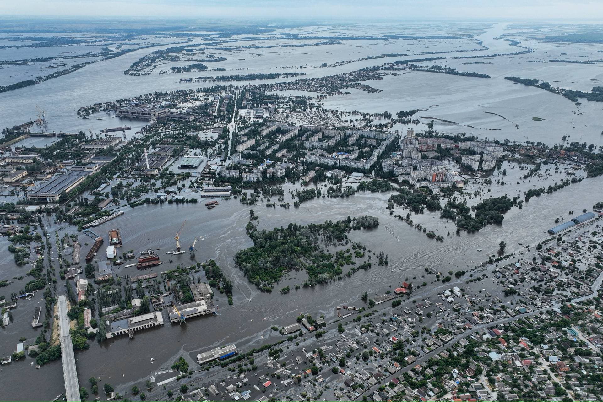 Houses are seen underwater and polluted by oil in a flooded neighbourhood in Kherson