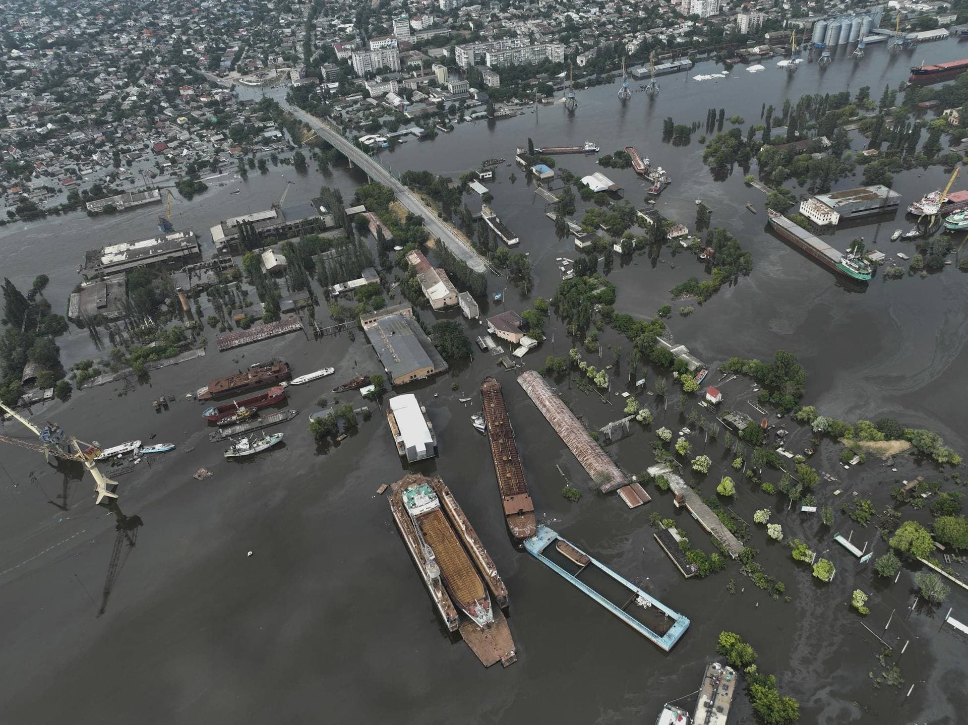 Streets and trade port are seen underwater and polluted by oil in the flooded Kherson