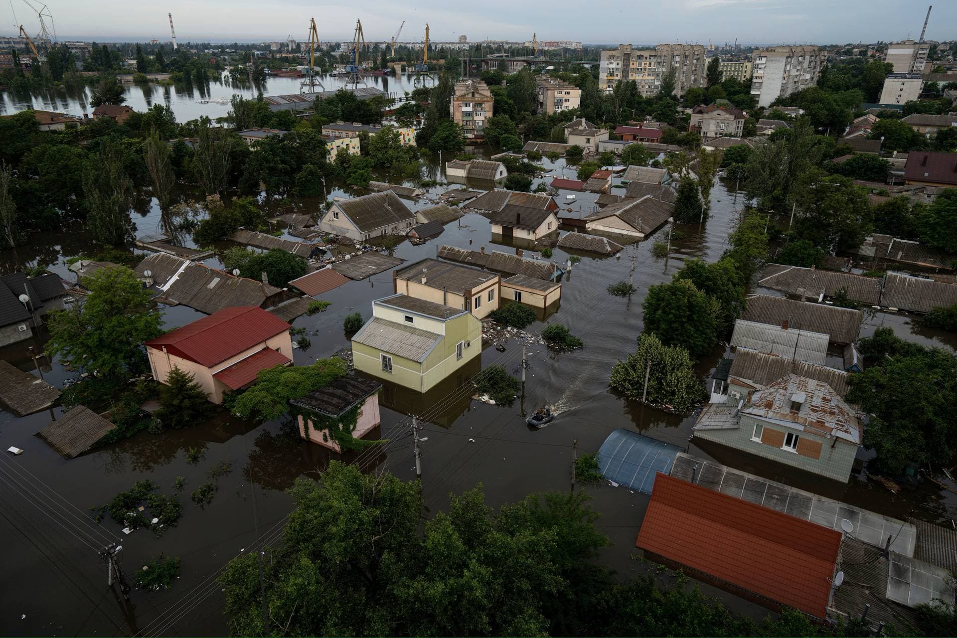Ukrainian servicemen ride by boat in a flooded neighborhood in Kherson