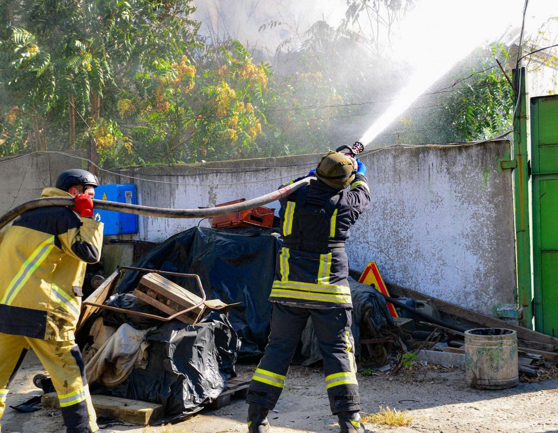 Firefighters work to extinguish a fire in a warehouse after shelling in Kherson
