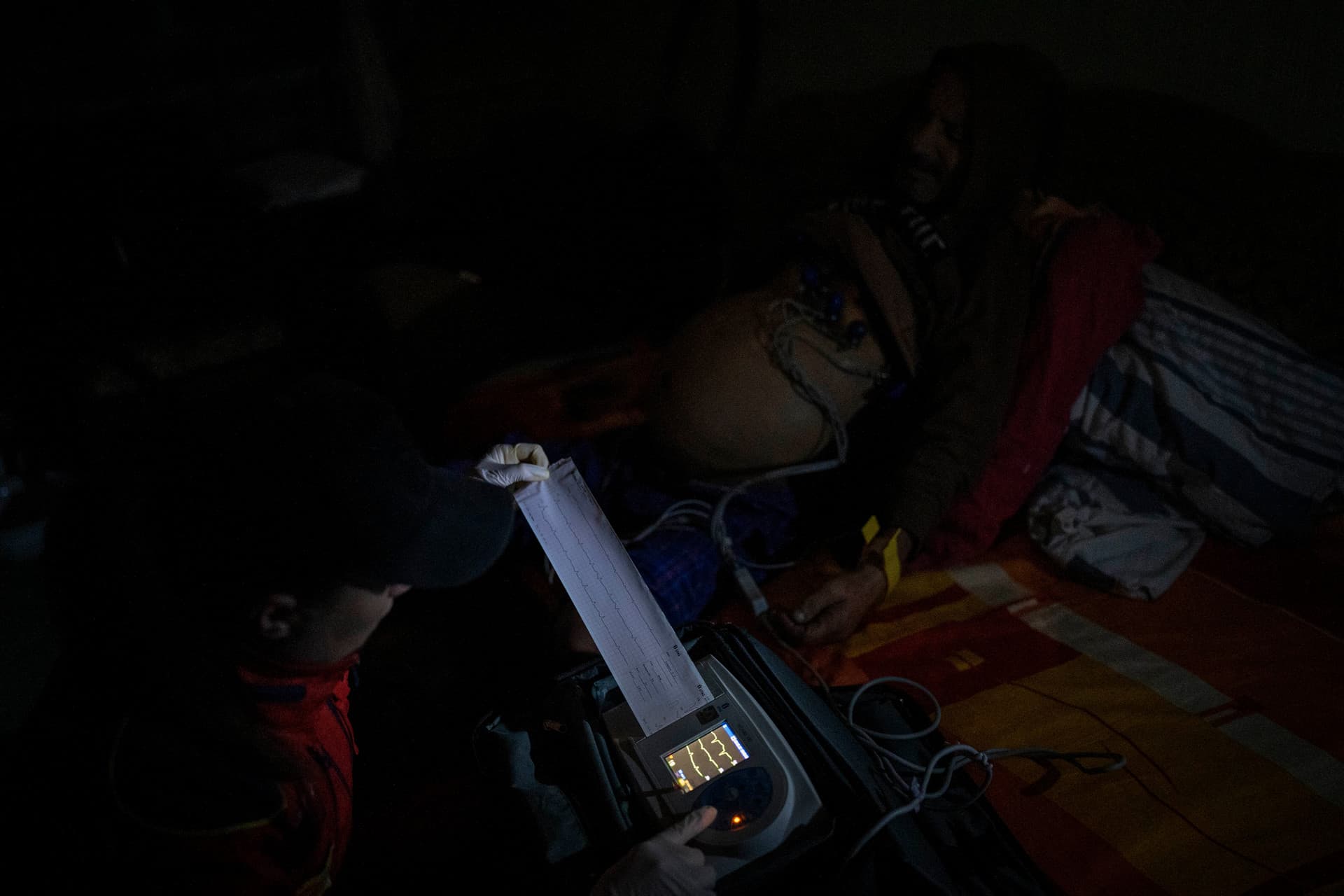 Ukrainian paramedic checks the vitals of a patient in Kherson