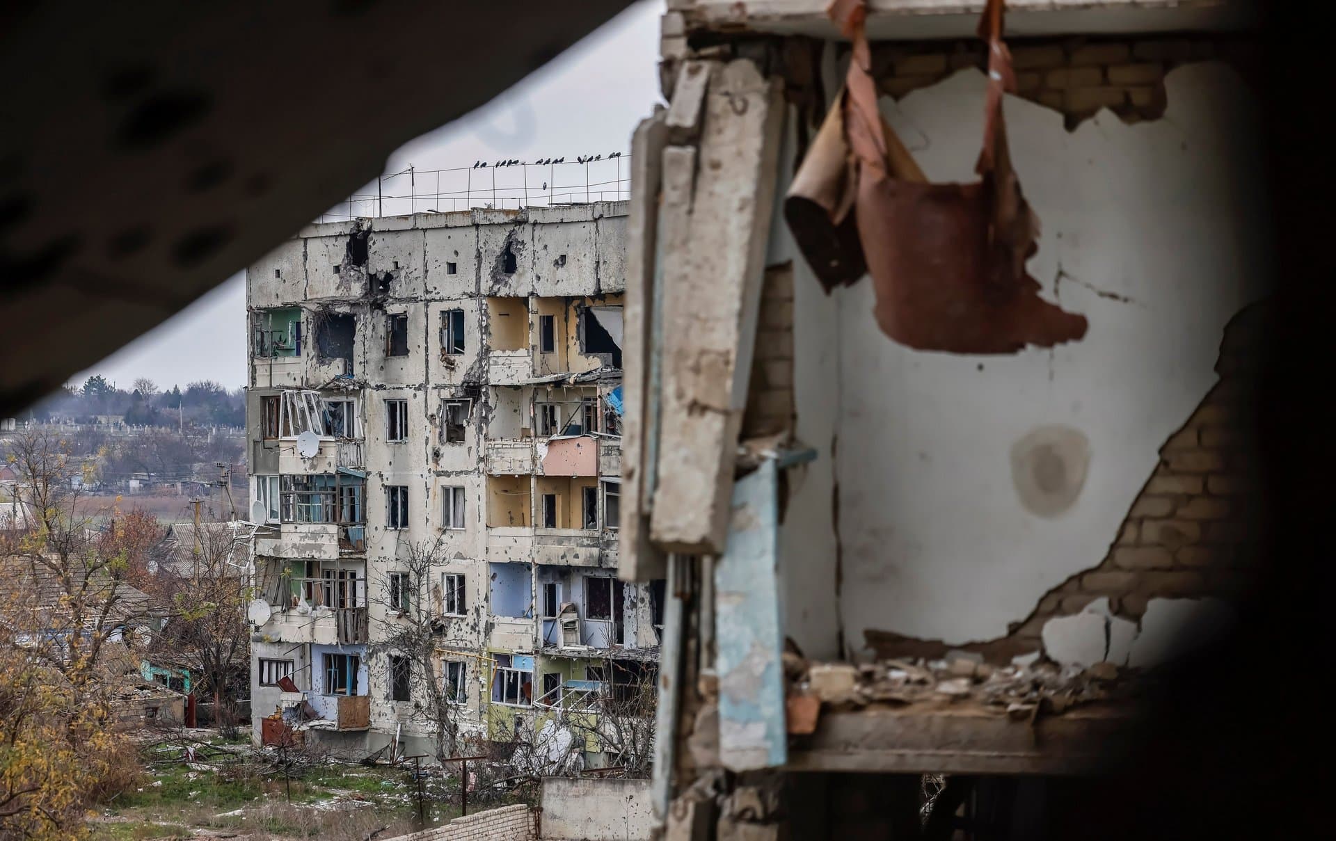A damaged residential building as seen from the destroyed vocational school in the northern Kherson region