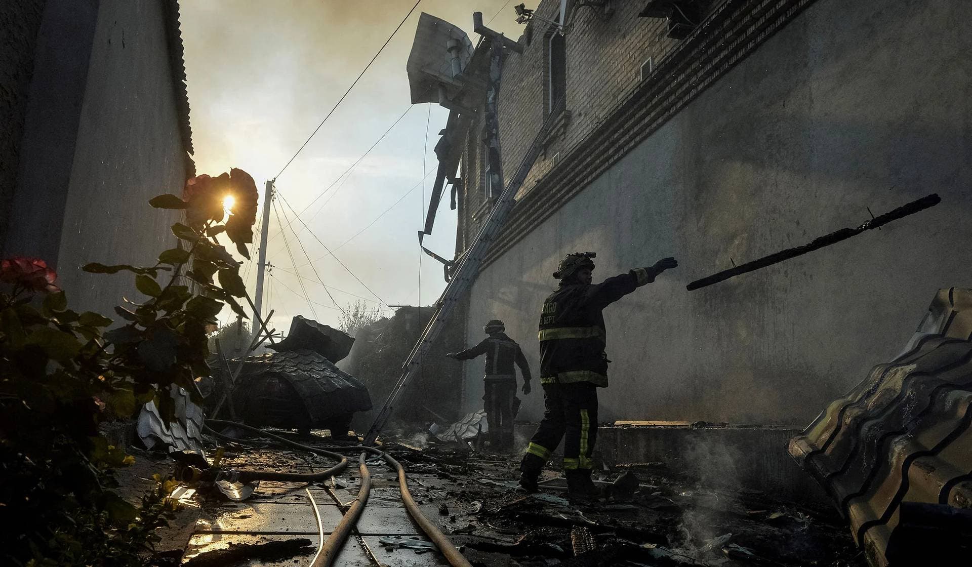 Rescuers work at a site of a private house heavily damaged in Russian shelling during the evacuation of local residents from a flooded area in Kherson