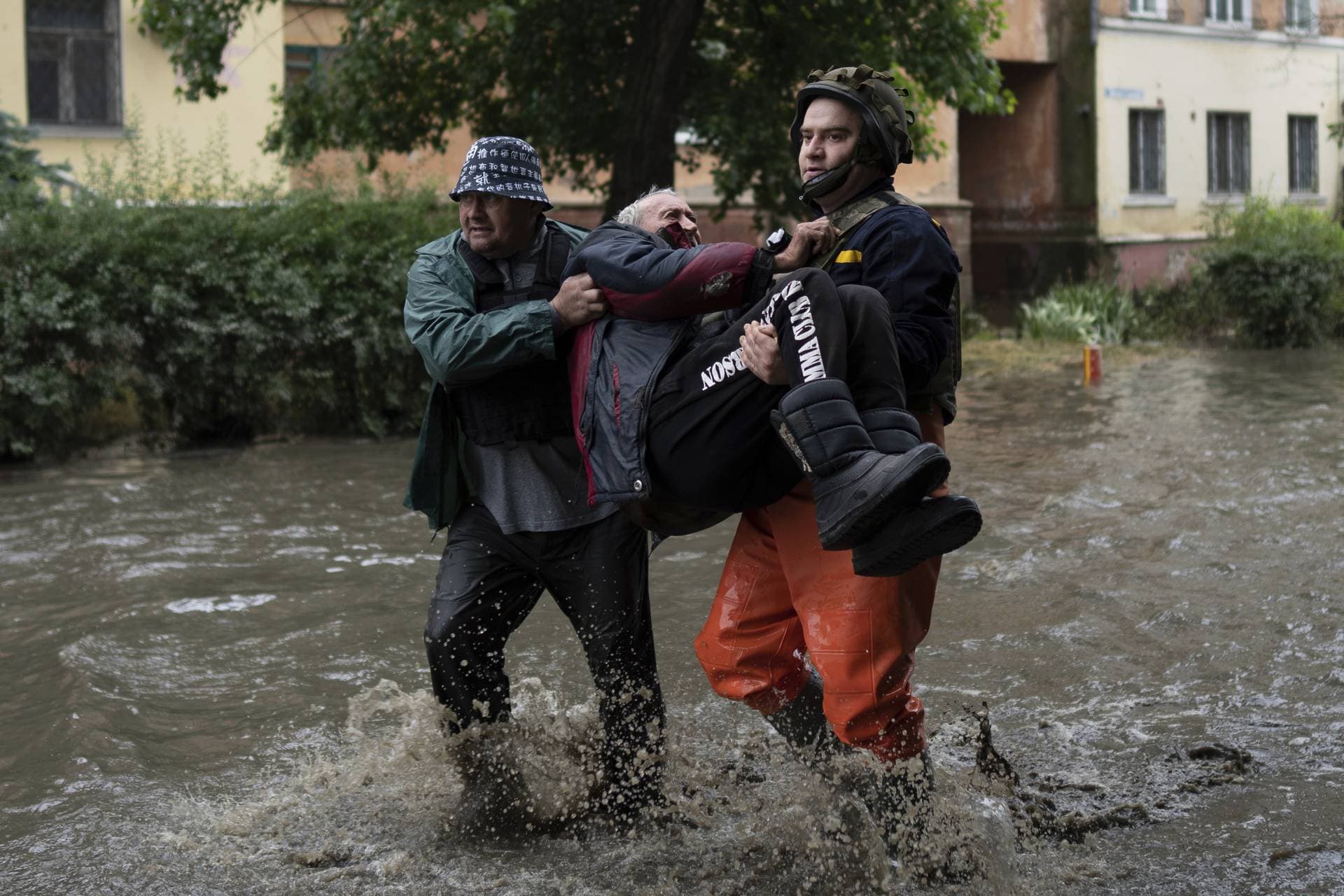 Emergency teams help rush to safety an evacuee on the western bank in Kherson