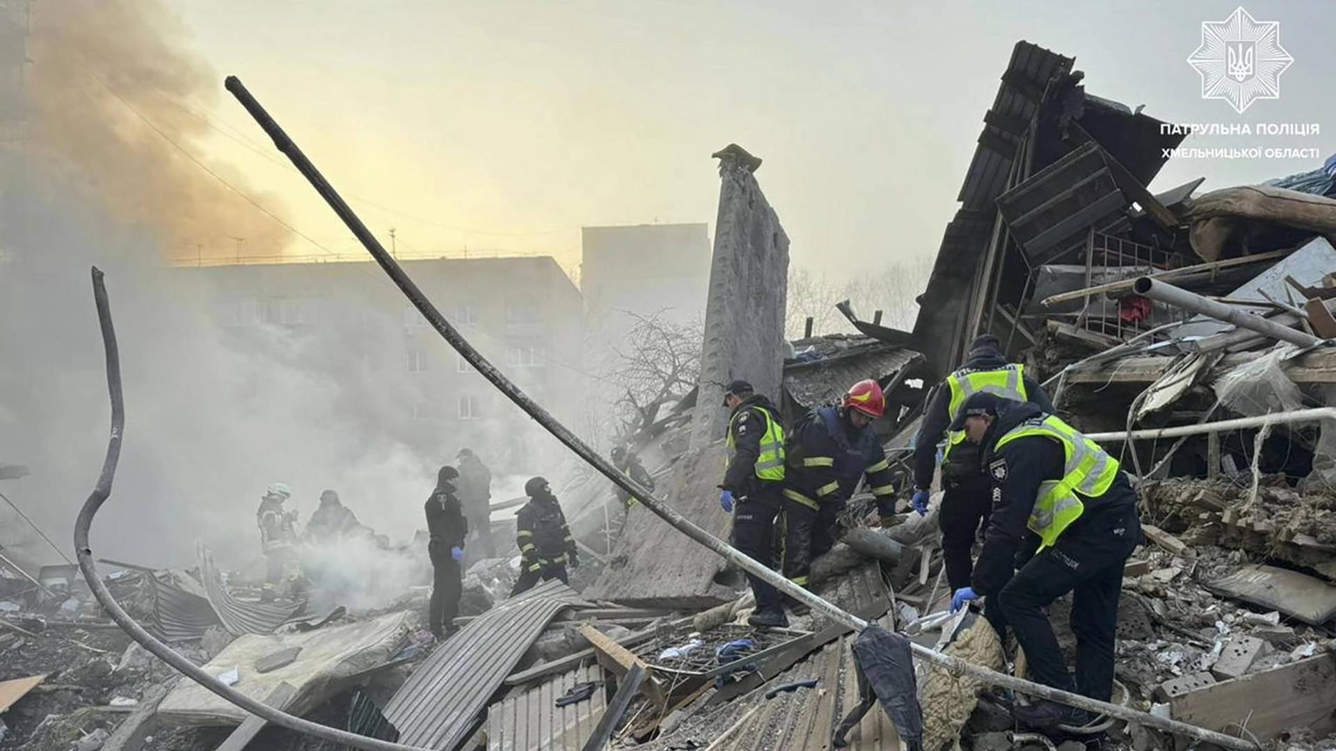 Rescuers and police officers work at a site of residential buildings heavily damaged by a Russian missile strike in Khmelnytskyi