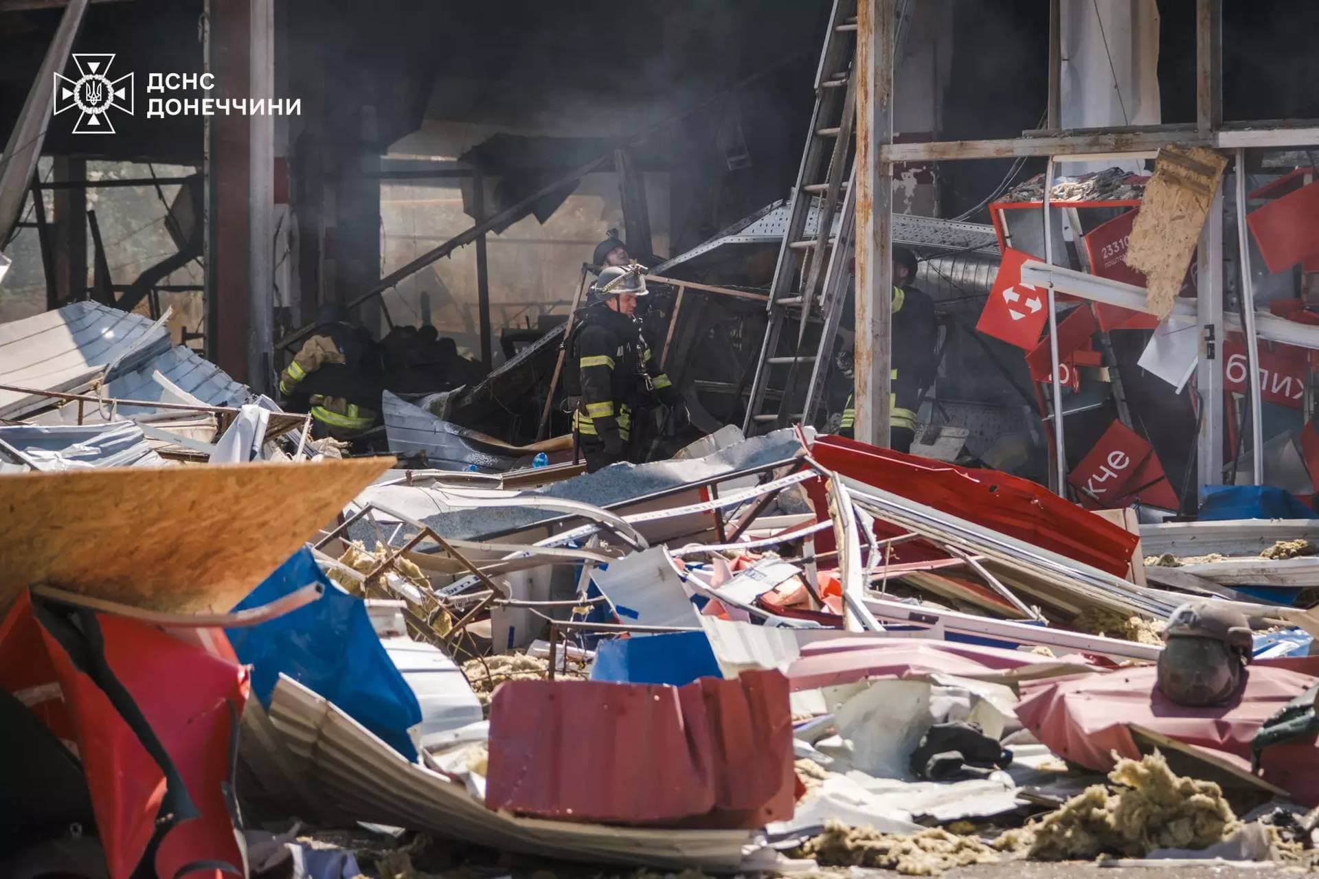 Firefighters work inside a supermarket heavily damaged by a Russian military strike in Kostiantynivka