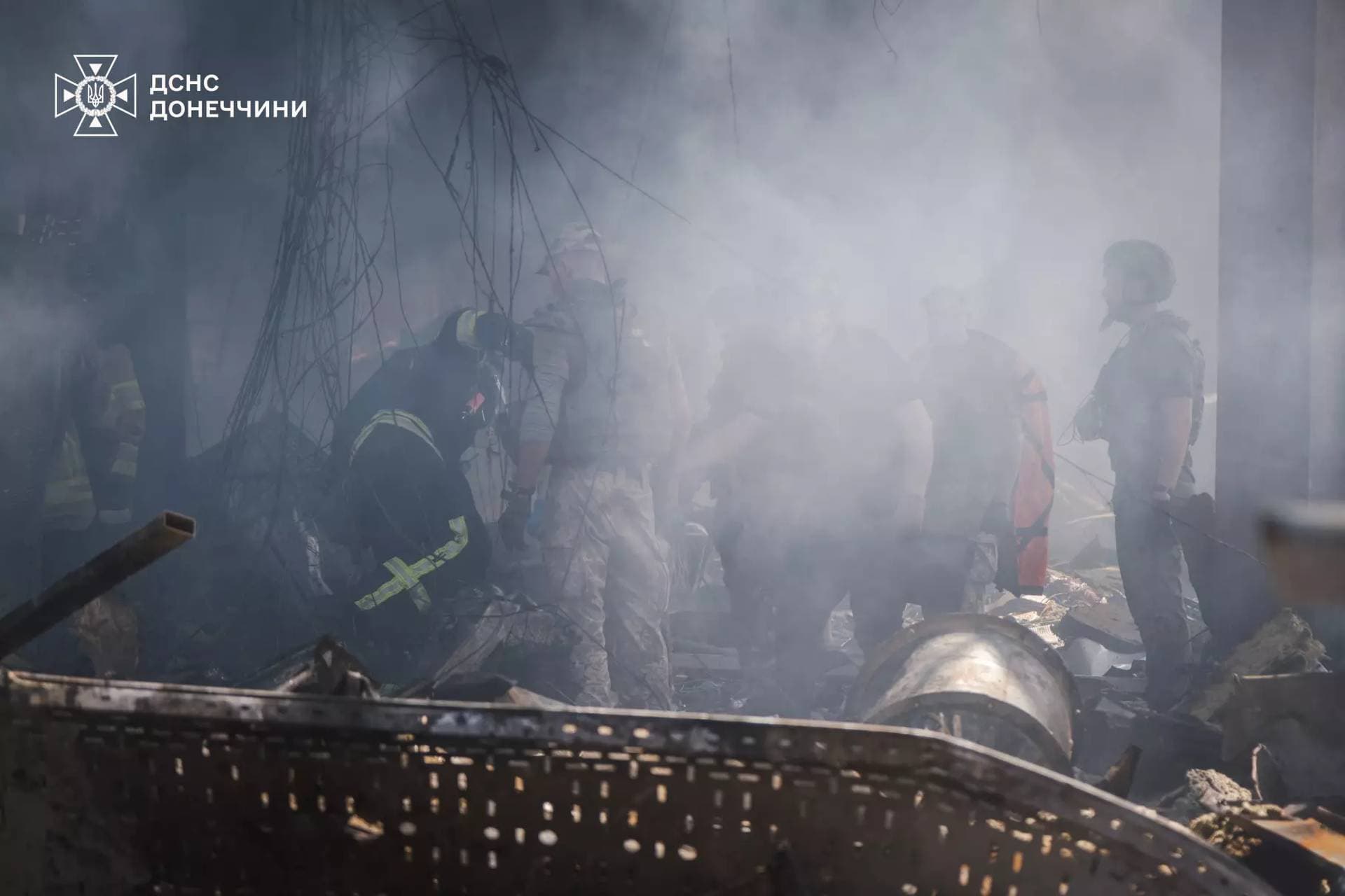 Firefighters work inside a supermarket heavily damaged by a Russian military strike in Kostiantynivka