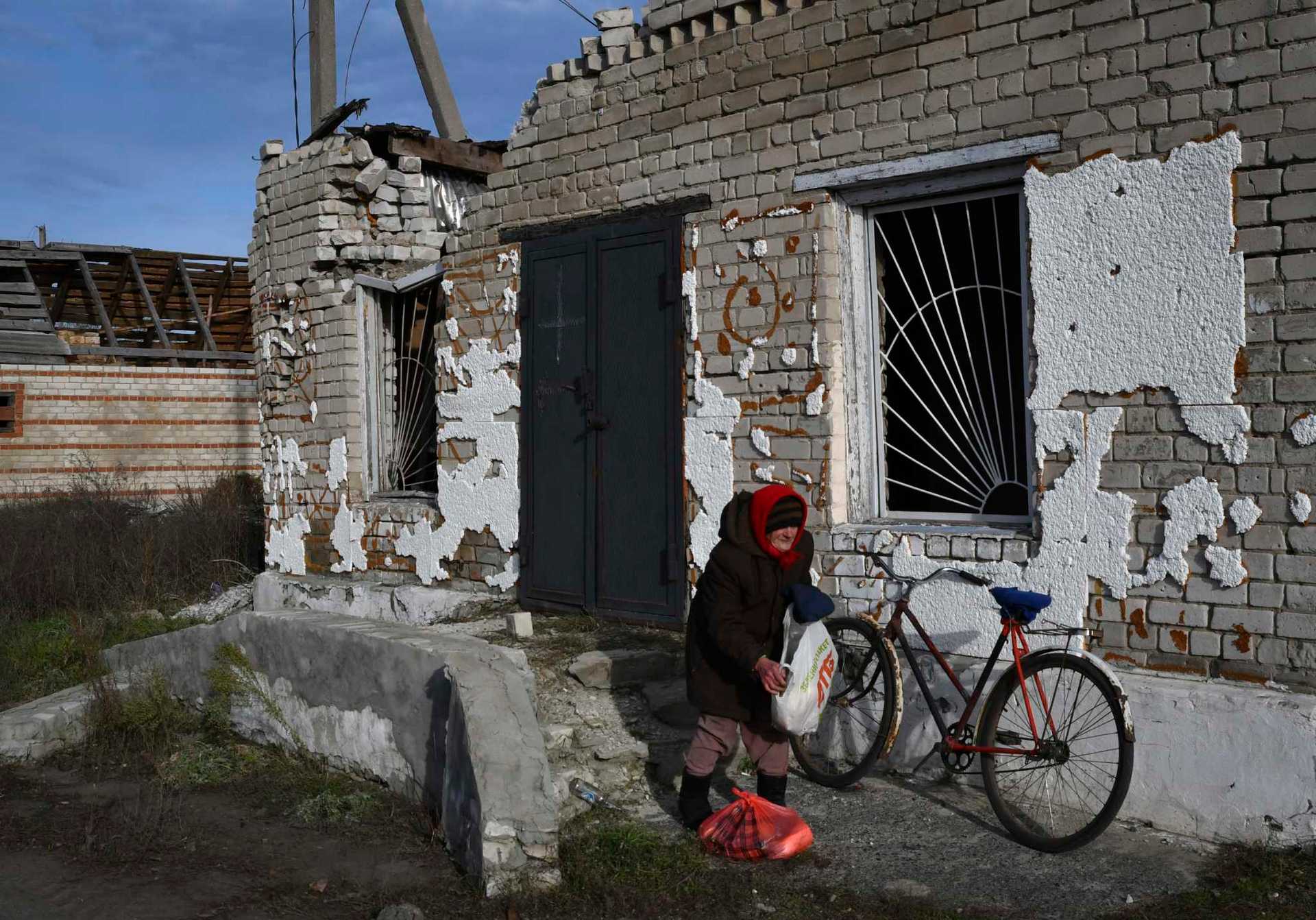 An elderly woman receives a food at a mobile humanitarian aid point in the village of Zarichne