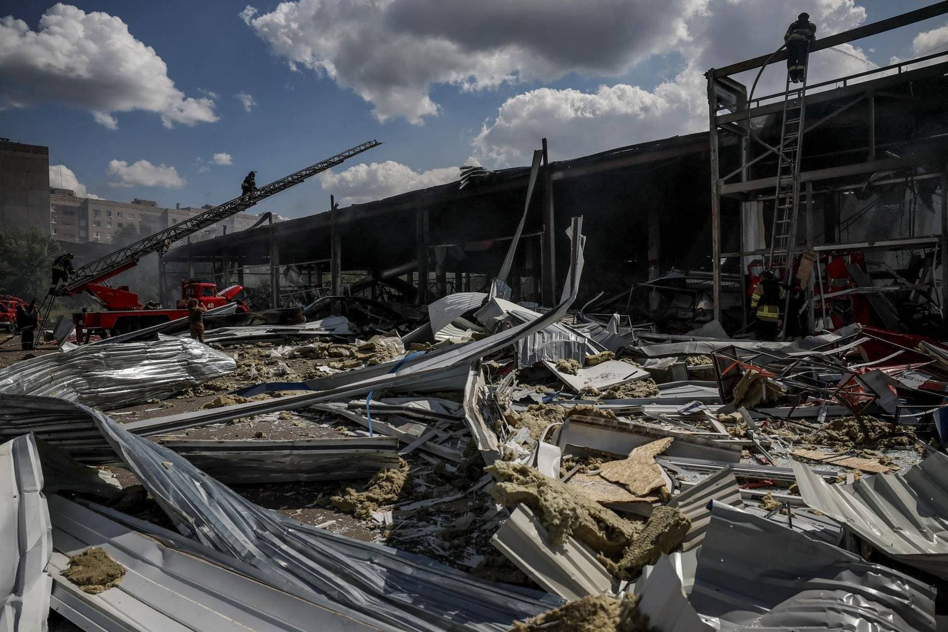 Firefighters work at a site of a supermarket heavily damaged by a Russian military strike in Kostiantynivka