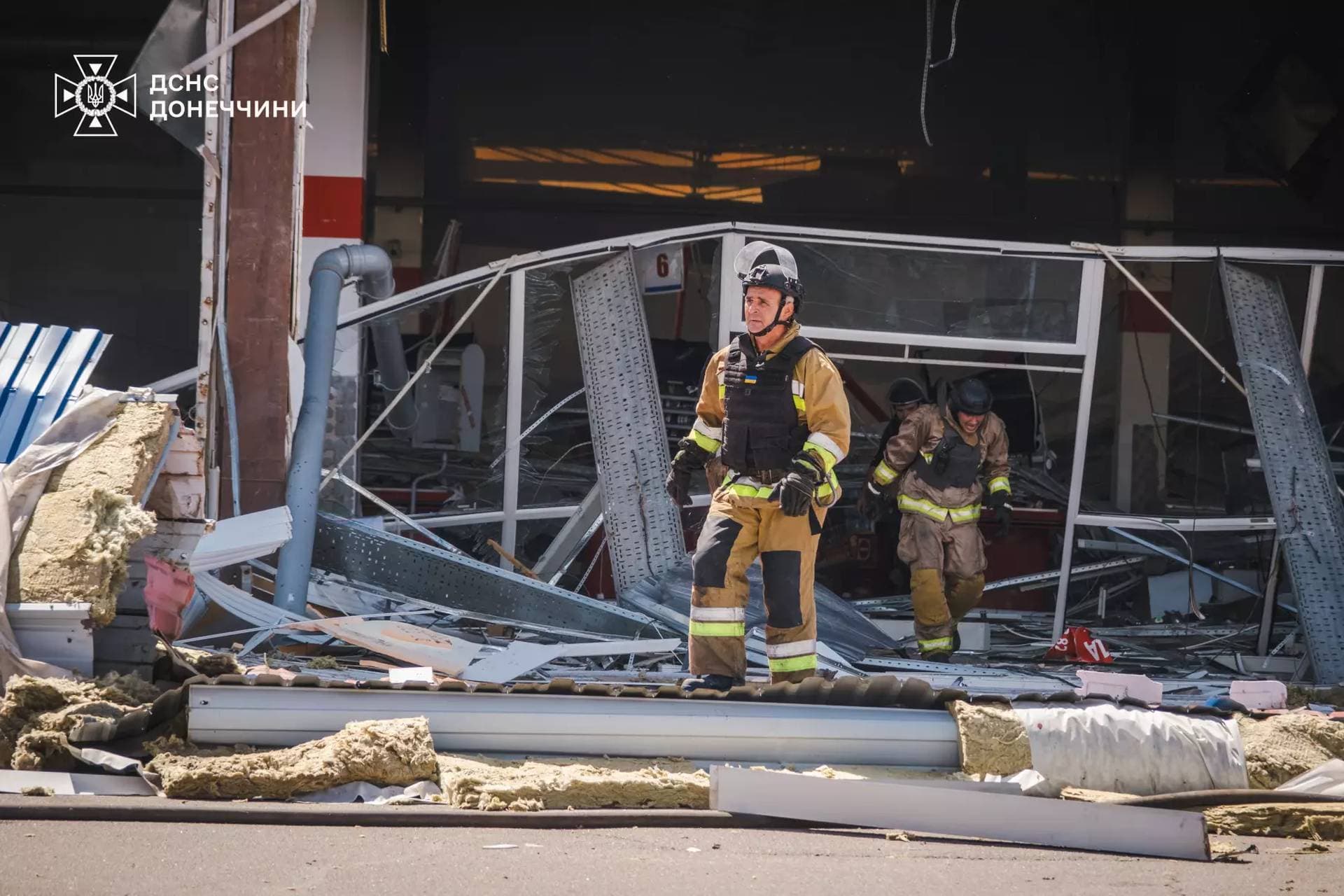 Firefighters work inside a supermarket heavily damaged by a Russian military strike in Kostiantynivka