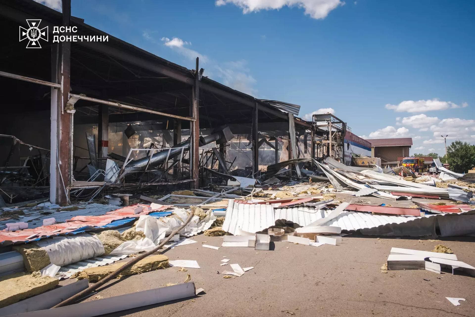 Firefighters work inside a supermarket heavily damaged by a Russian military strike in Kostiantynivka