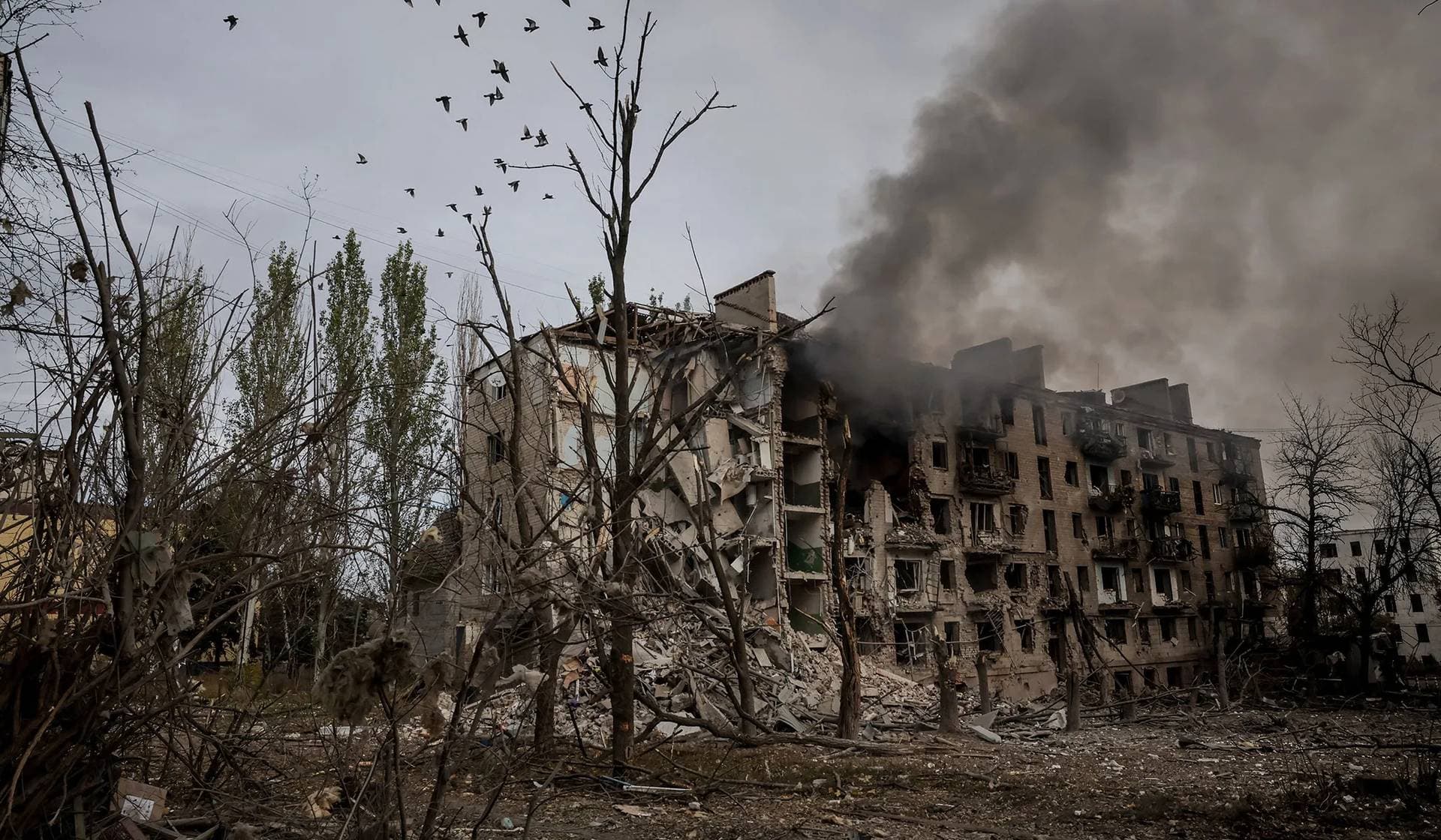 Smoke rises from apartment buildings damaged by Russian military strike in the frontline town of Kostiantynivka