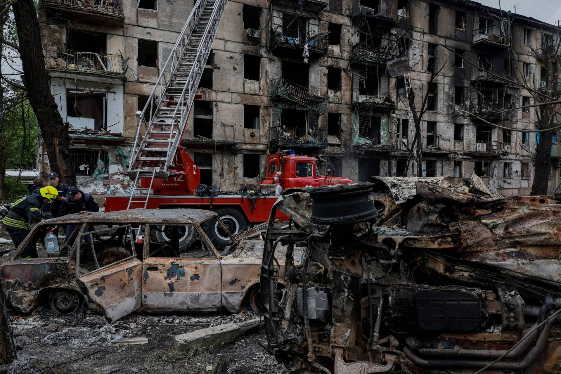 Rescue workers near the heavily damaged residential building