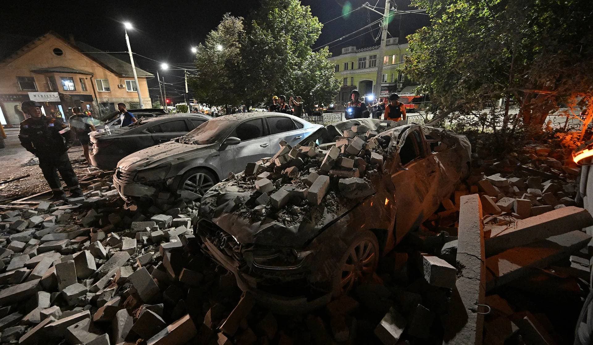Rescuers work at the site of an apartment building hit by a Russian missile strike in Kryvyi Rih