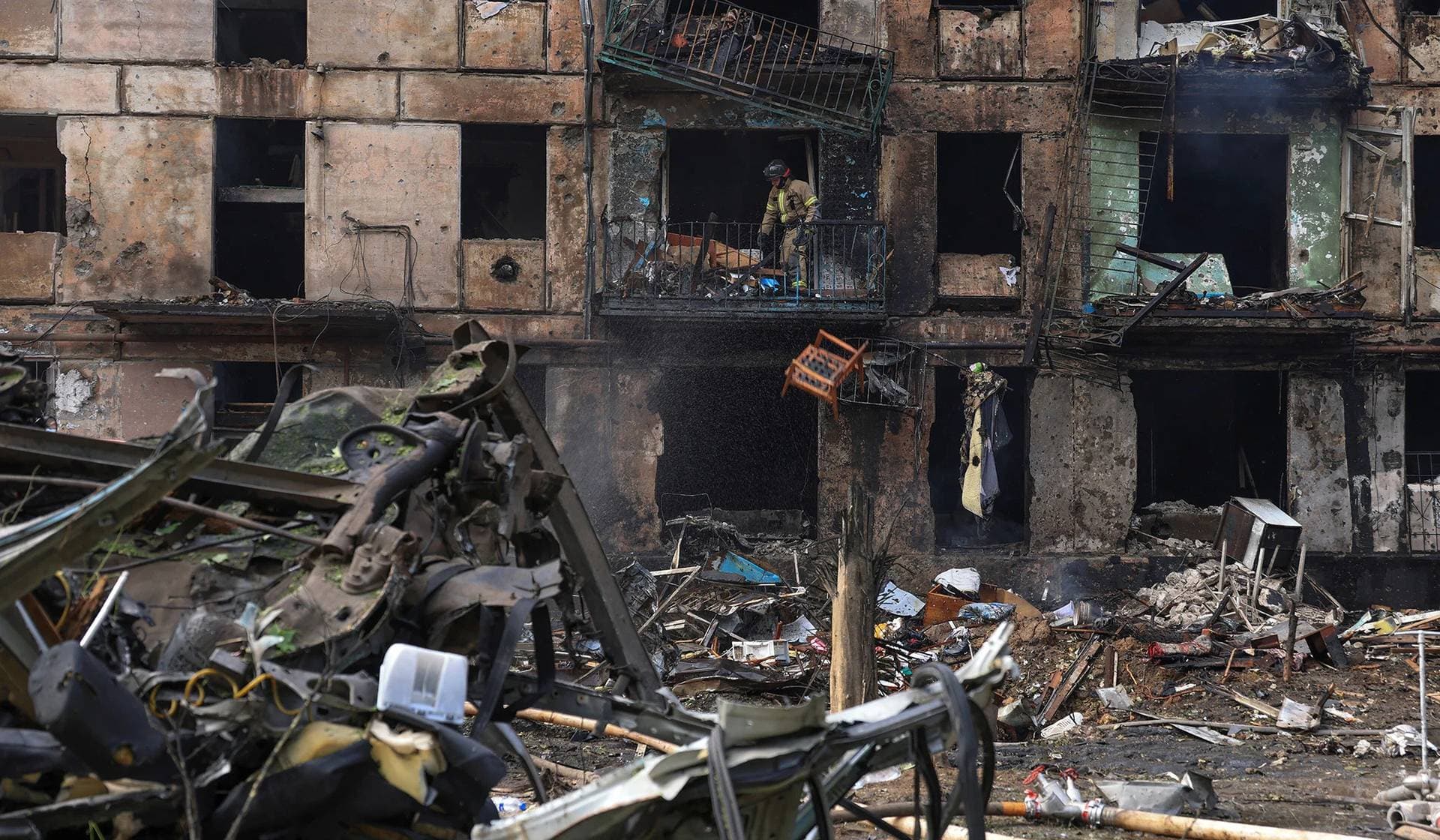 A rescuer works at the site of a residential building heavily damaged by a Russian missile strike in Kryvyi Rih