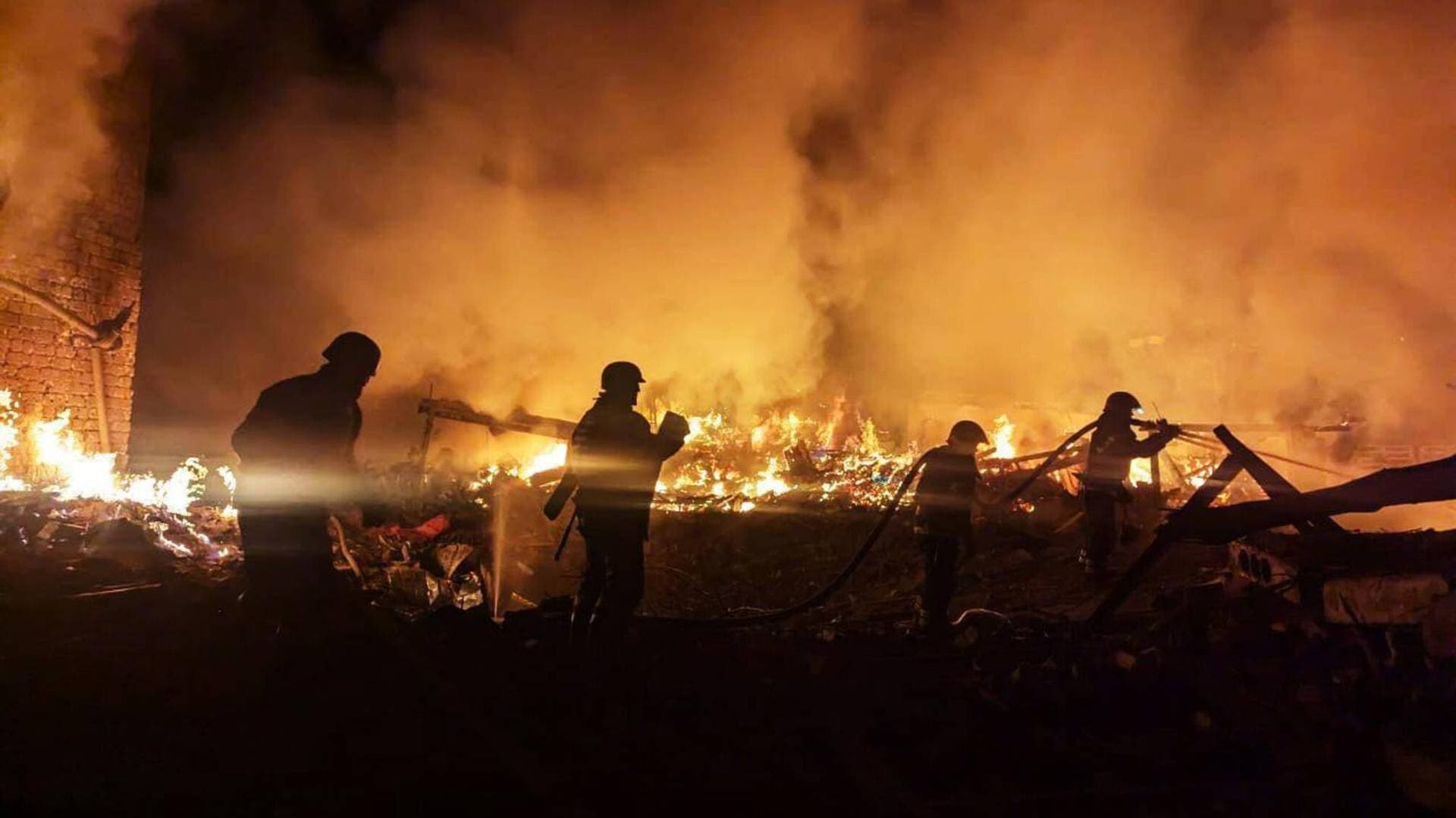 Firefighters work at a site of a Russian missile strike in Kryvyi Rih