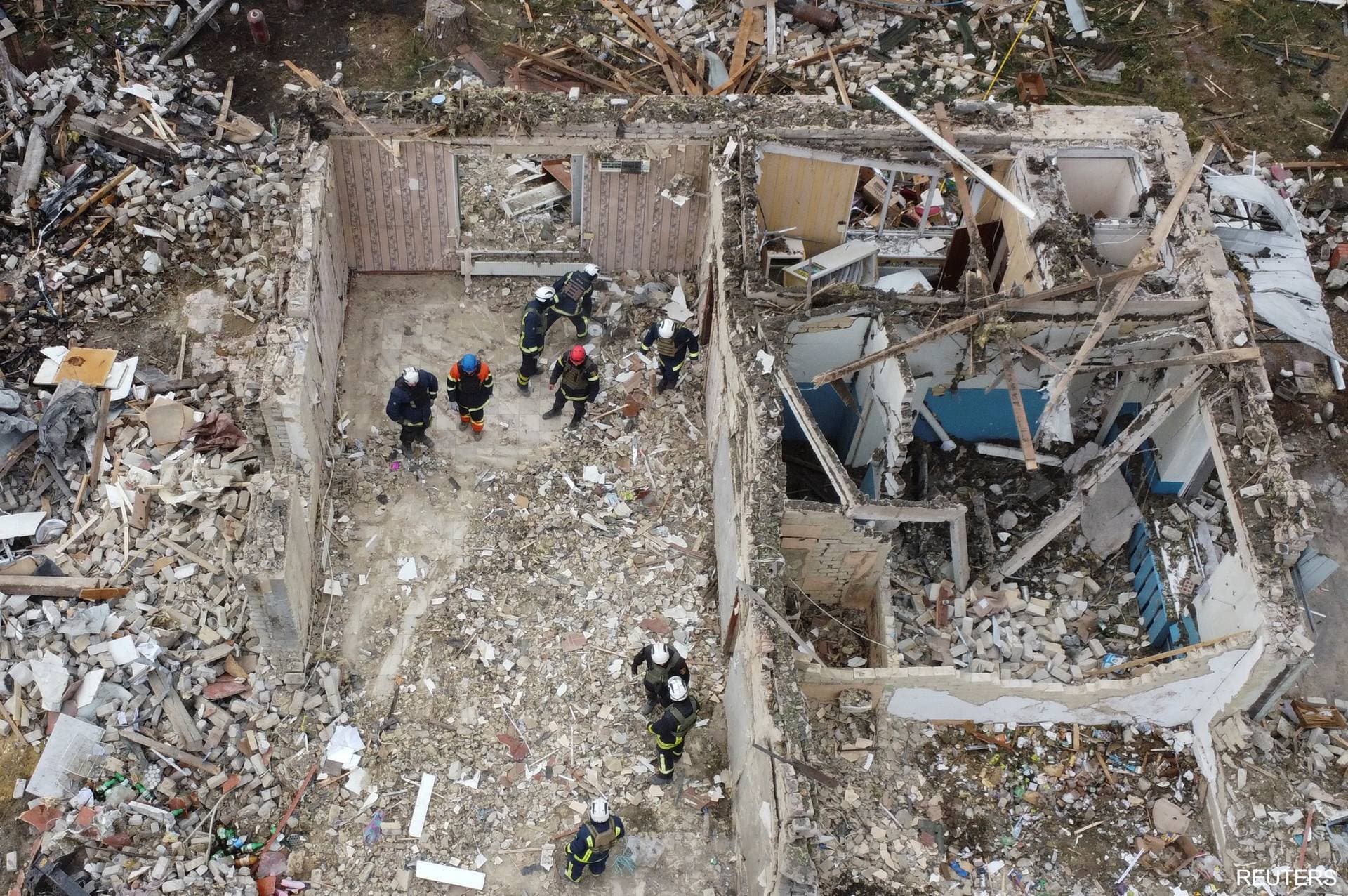 Rescues remove debris at a site of buildings of a local cafe and a grocery store in the village of Hroza