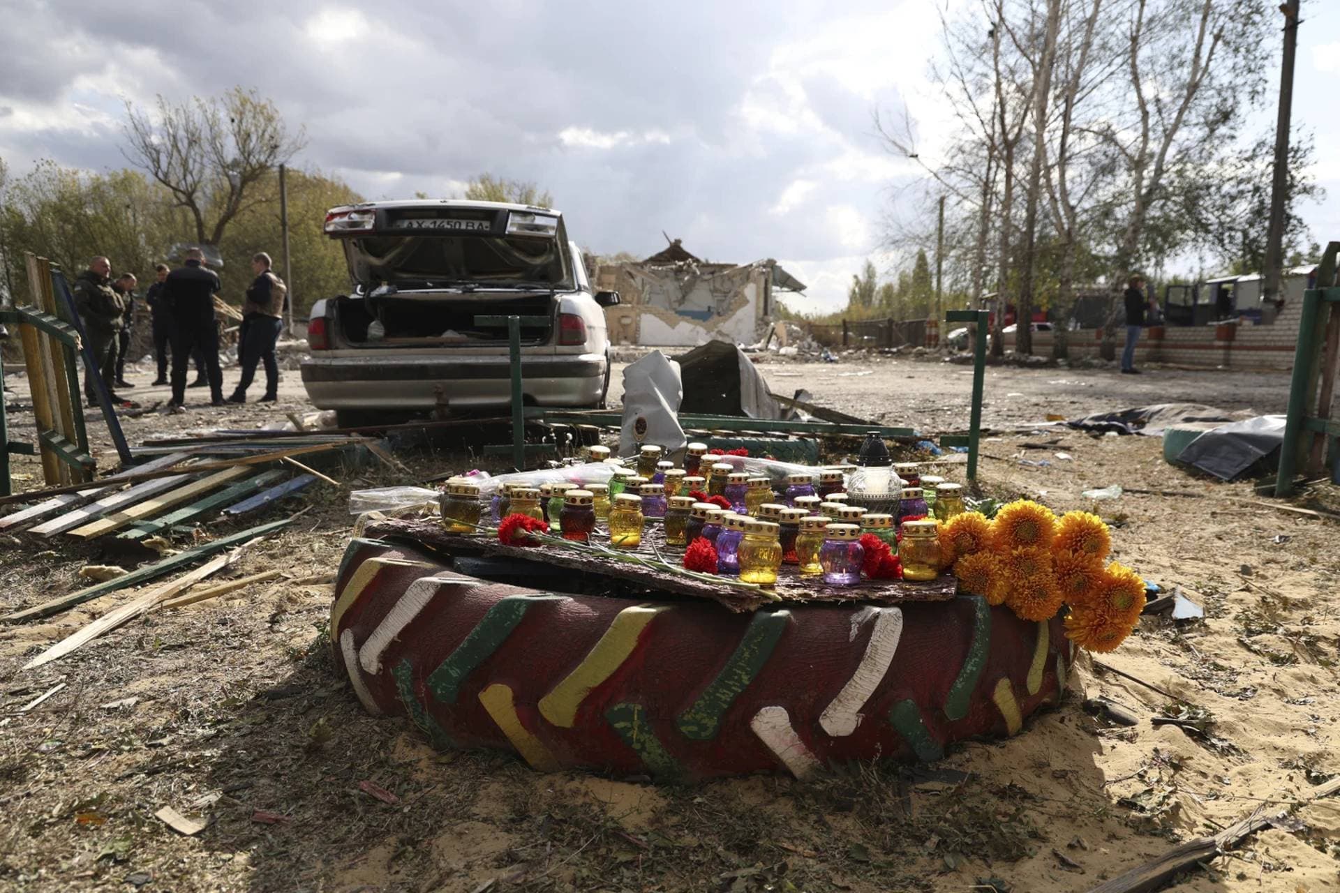 A memorial made with candles and flowers in the village of Hroza