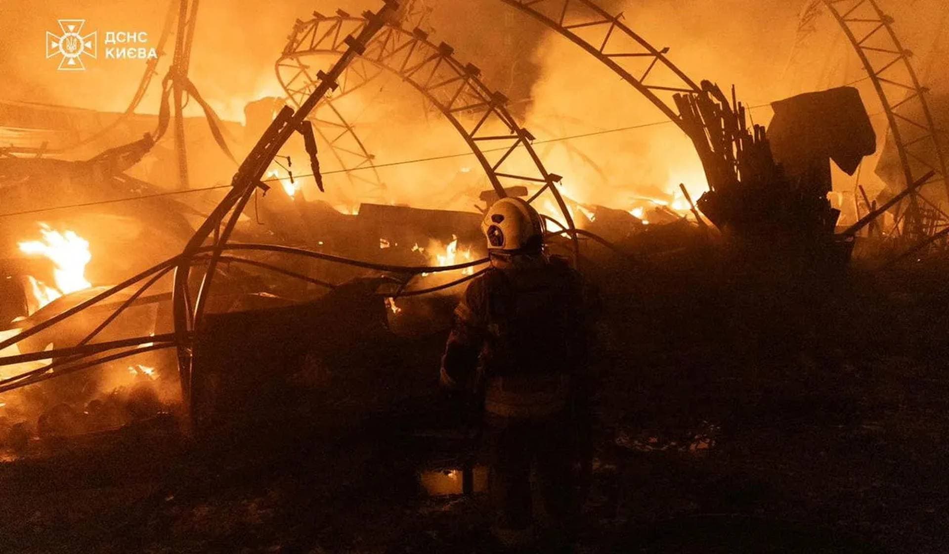 Firefighters work at the site of a Russian drone strike in Kyiv