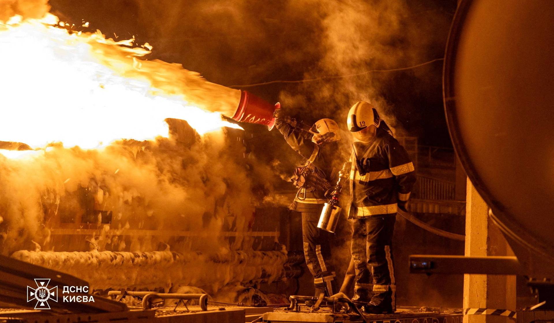Firefighters work at the site of a Russian drone and missile strike in Kyiv