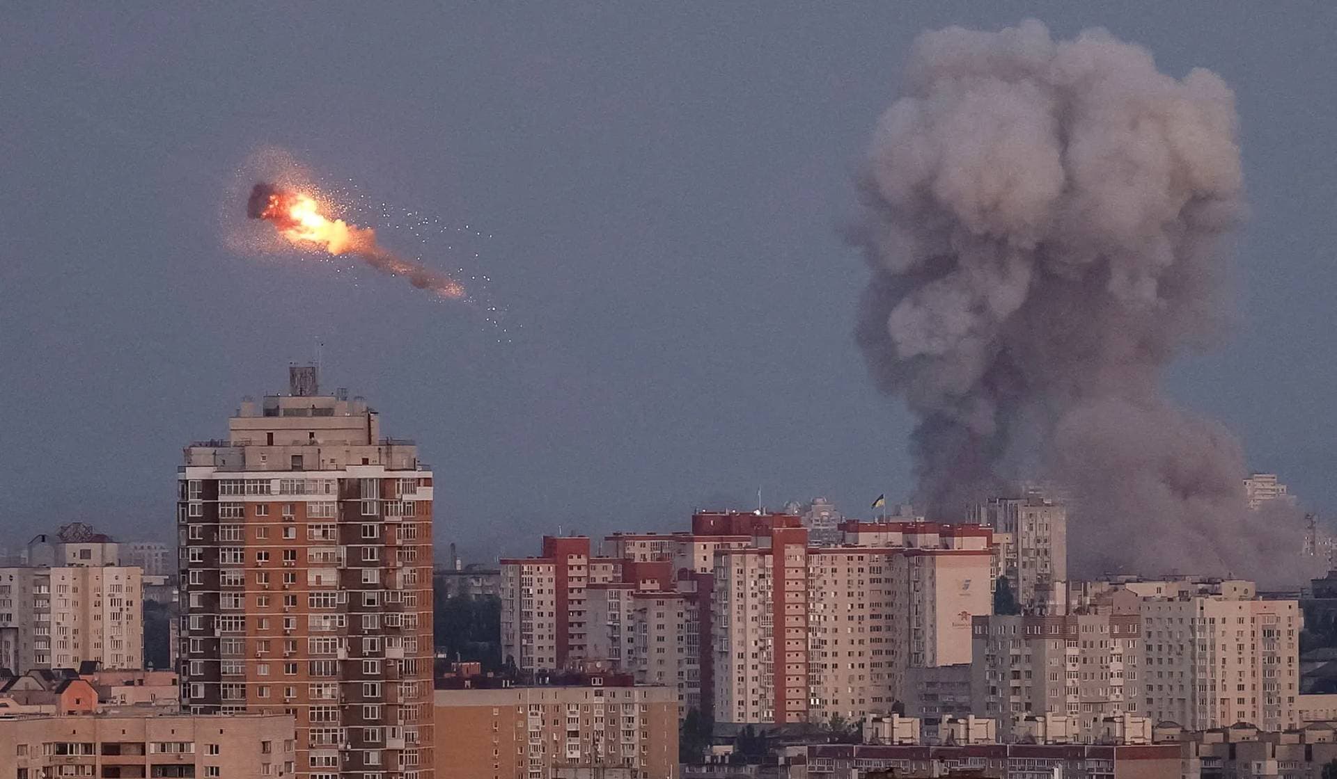 Ukrainian servicemen shoot down a Russian missile as smoke rises from the city during a Russian missile strike in Kyiv