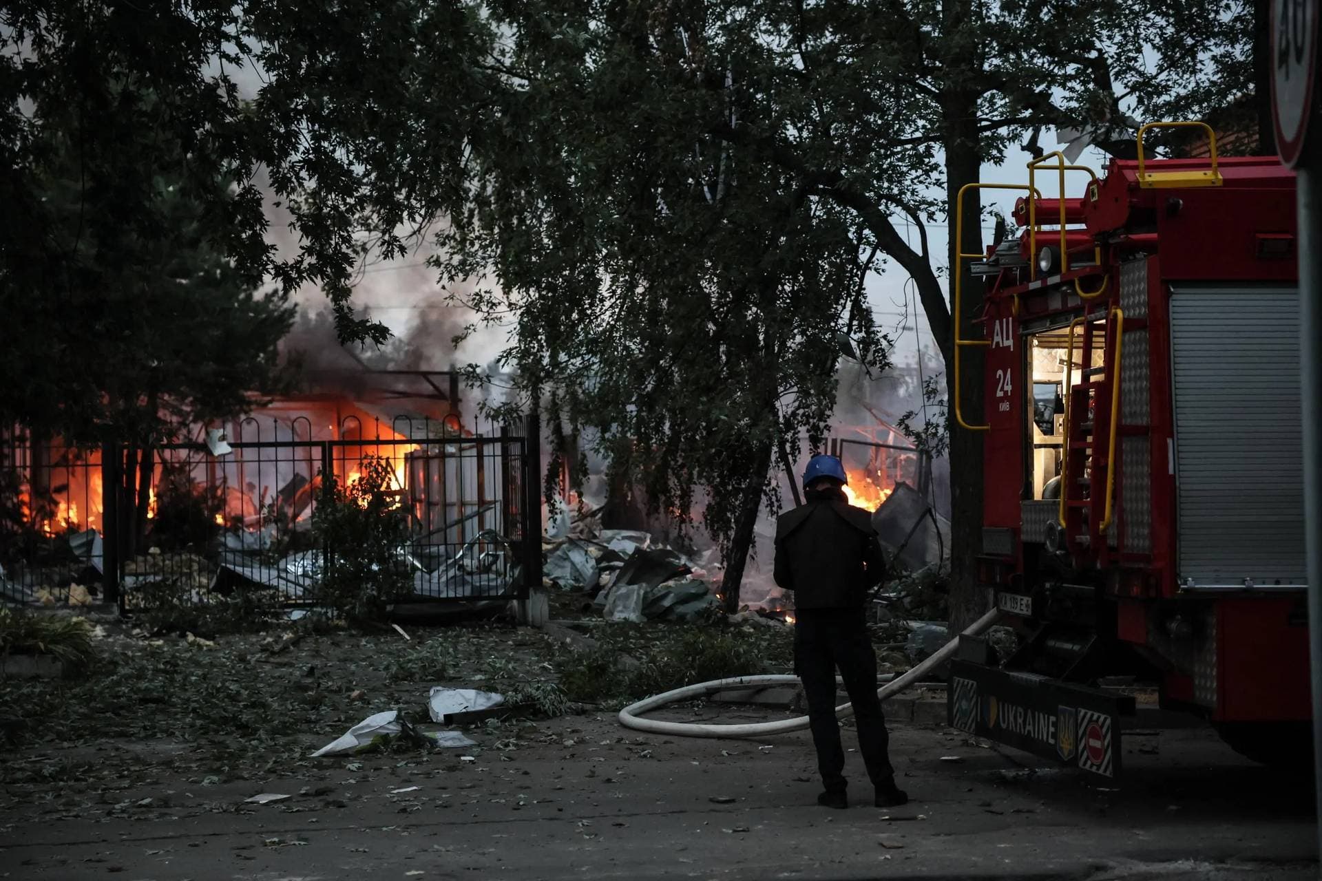 Ukrainian rescue service members work at the site of a missile strike on a residential area in Kyiv