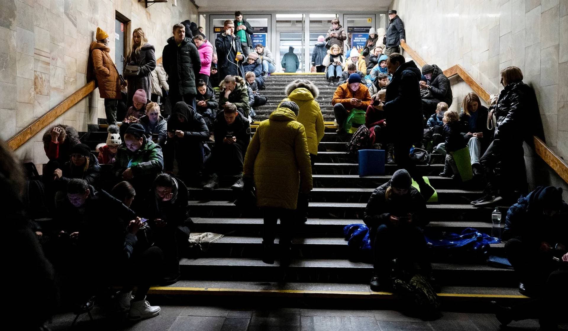 People take shelter inside a metro station during massive Russian missile attacks in Kyiv