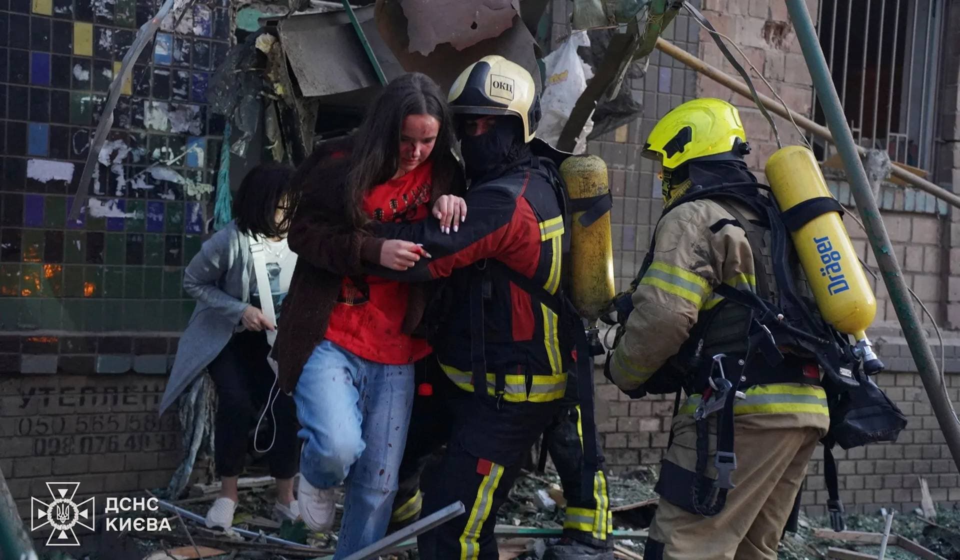Rescuers evacuate residents from a building damaged during a Russian missile strike in Kyiv